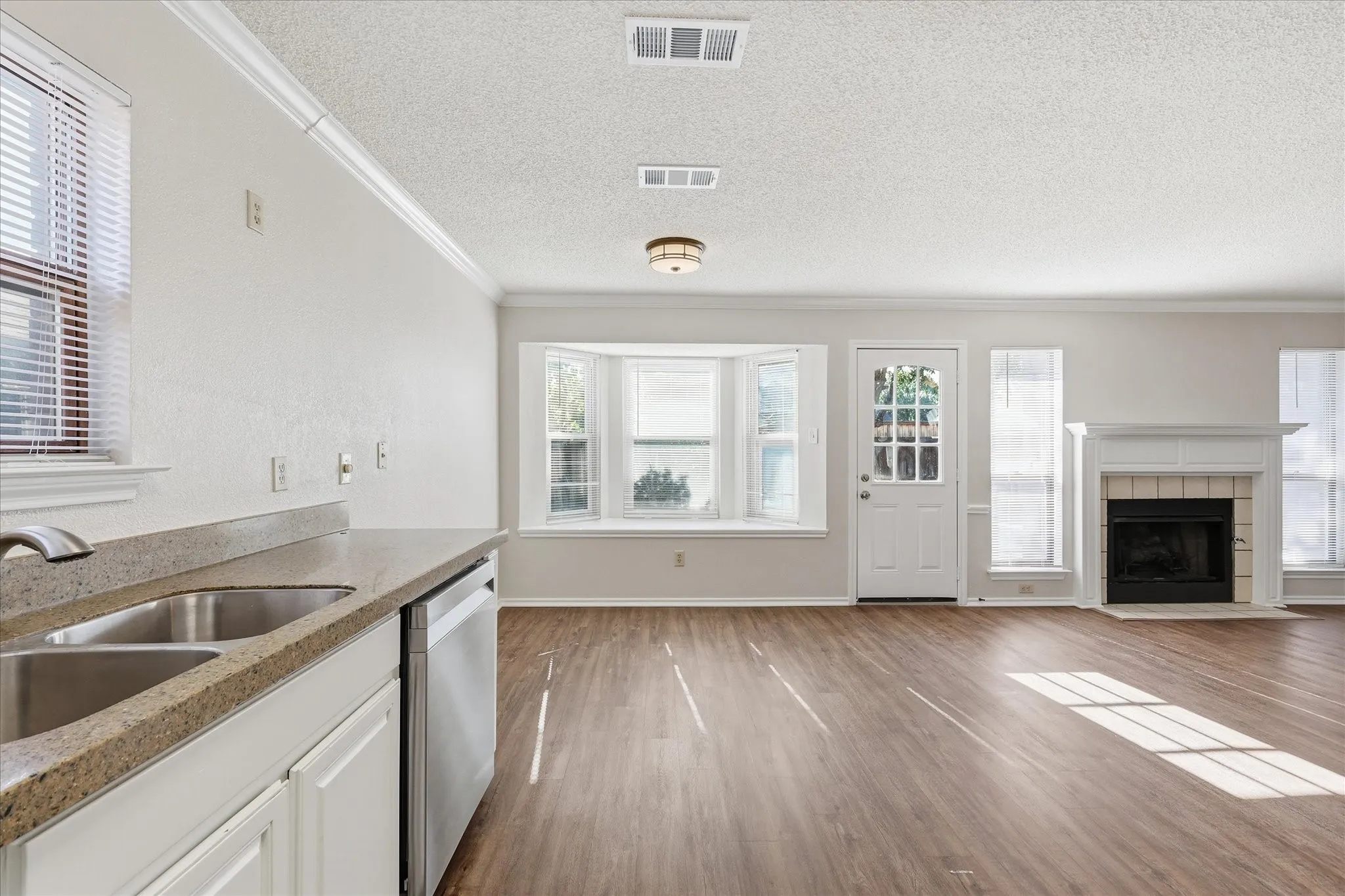 Bright and open, the kitchen and breakfast area feature stainless appliances, ample natural light and a welcoming fireplace view