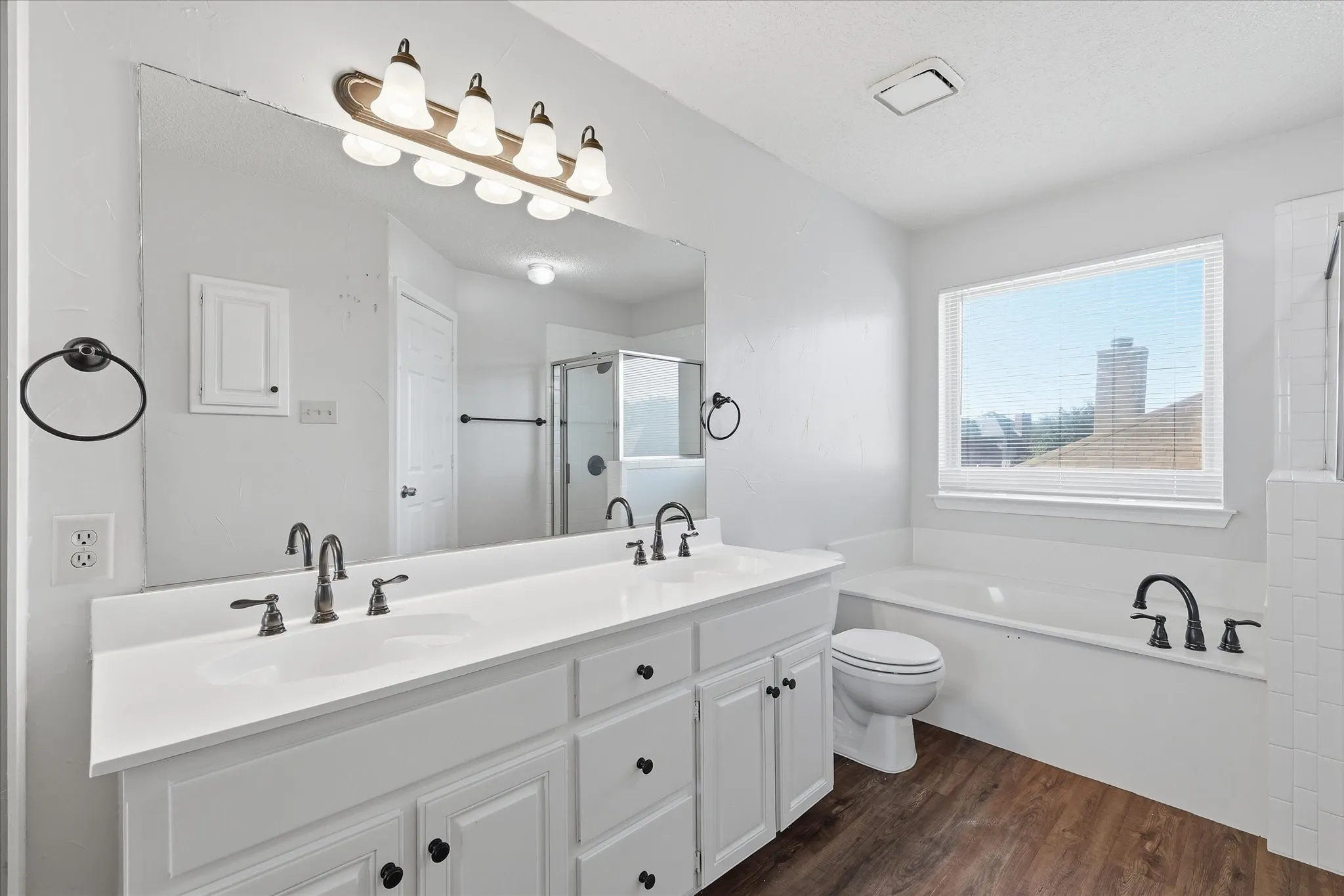 The generous primary suite offers a peaceful, light-filled atmosphere with an adjoining bath and flexible room for furnishings.