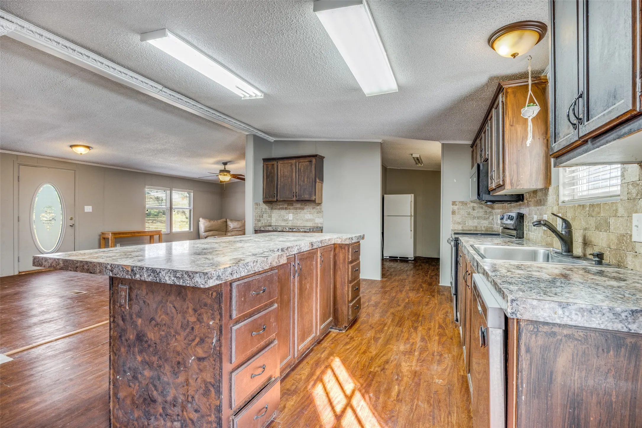 Chef's dream kitchen over looking pantry with enough room for extra fridge and a freezer!  Large stainless sink and smooth-top range with double ovens and travertine backsplash!  This kitchen has it all!