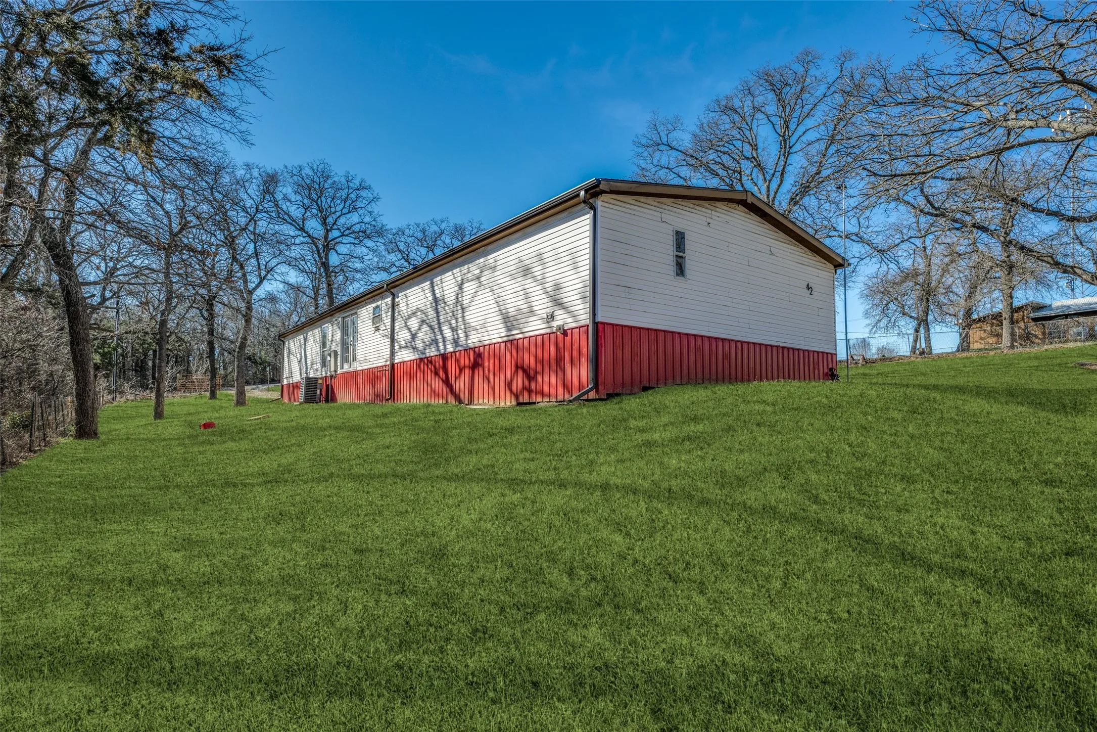 Large back yard with virtually staged grass!