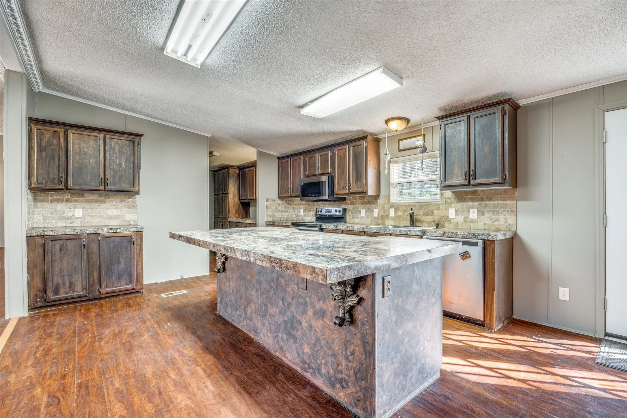 Kitchen with large island and lots of cabinets!  Large serving bar or great for breakfast on the barstools!