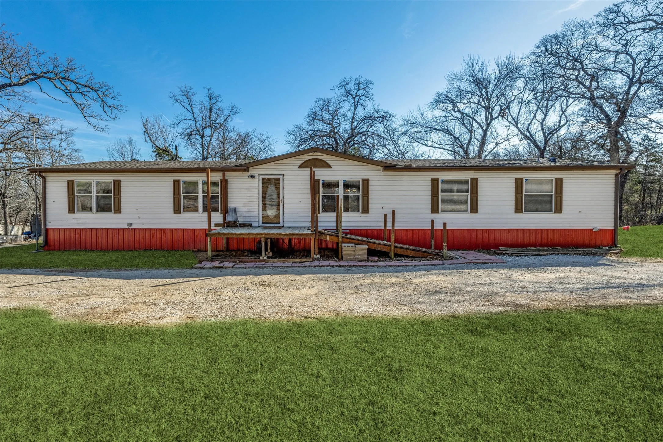 Front of home with deck and ramp for easy entrance