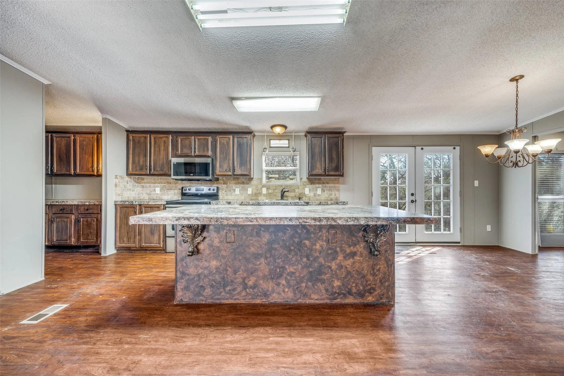 Kitchen/Breakfast room with double French doors leading to the backyard.  Tons of Cabinets including in the huge pantry.