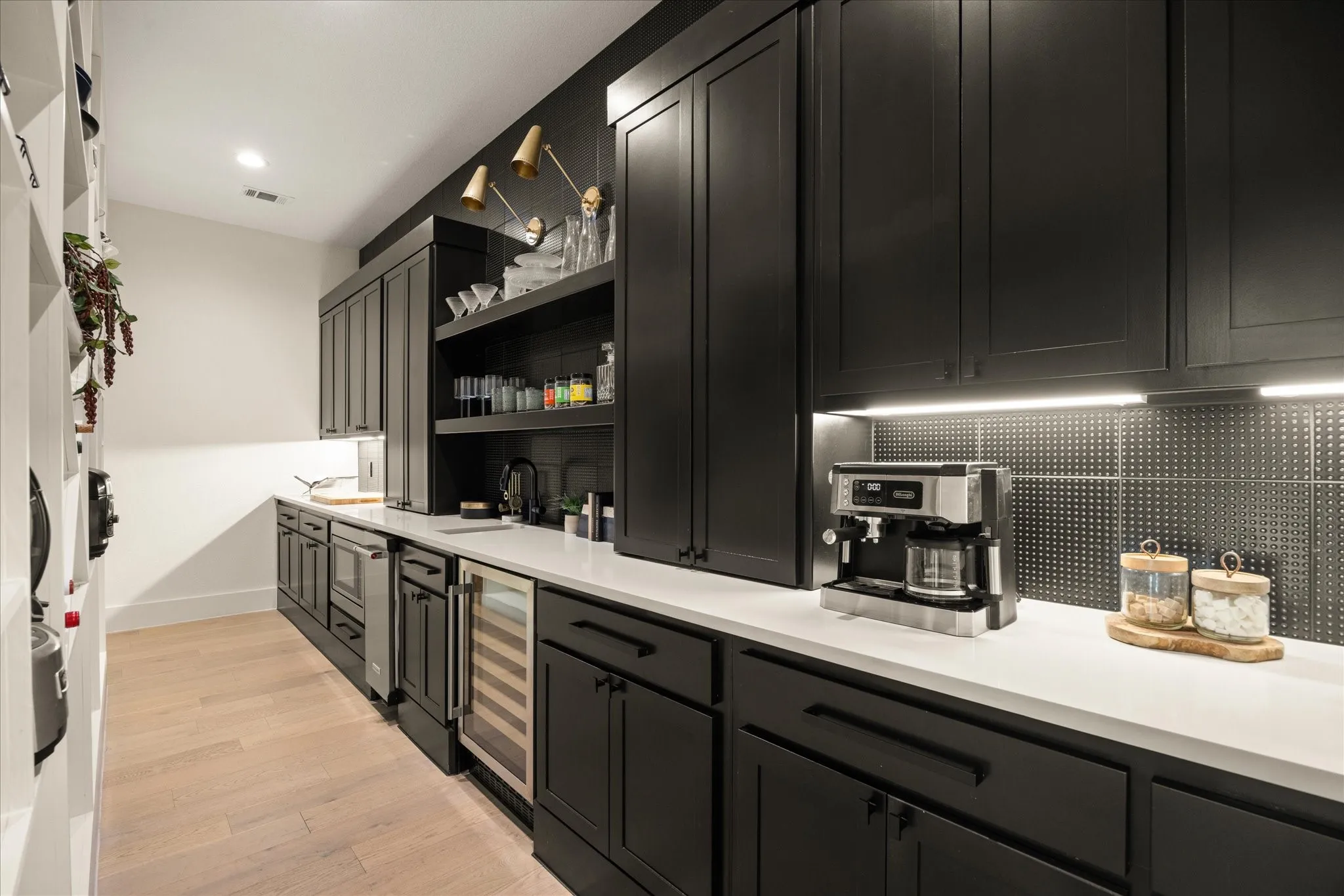 Built in fridge and wine fridge and an abundance of cabinet space.
