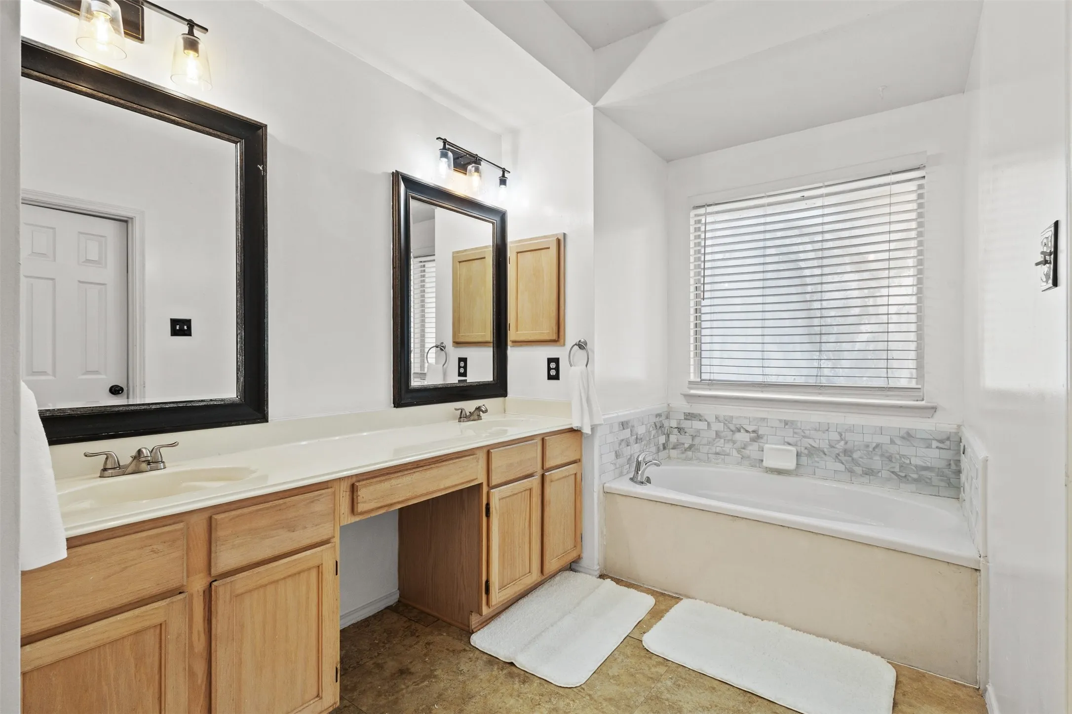 Dual vanity with integrated sinks and black framed mirrors