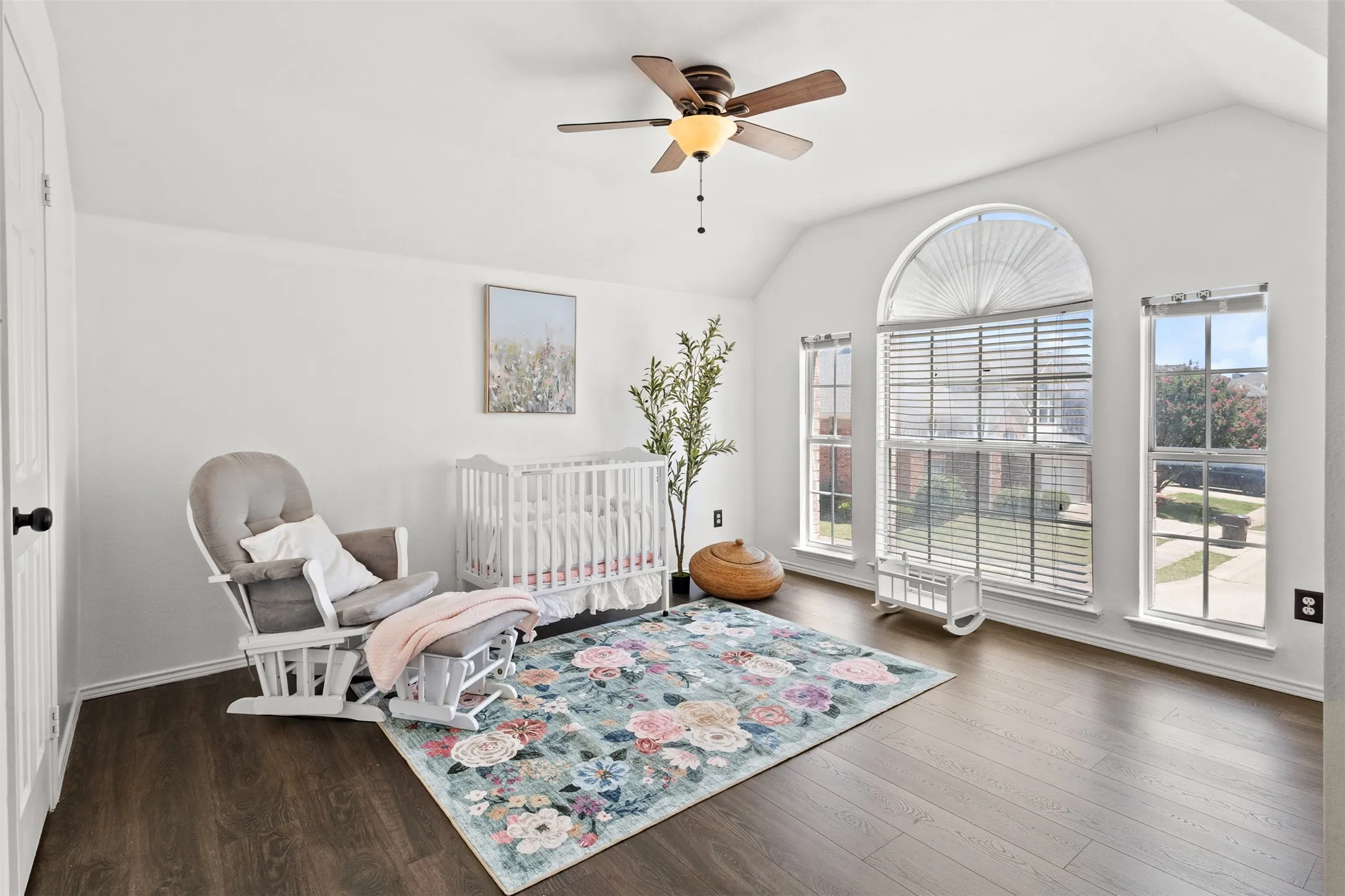 Vaulted white ceilings featuring a ceiling fan with integrated lighting