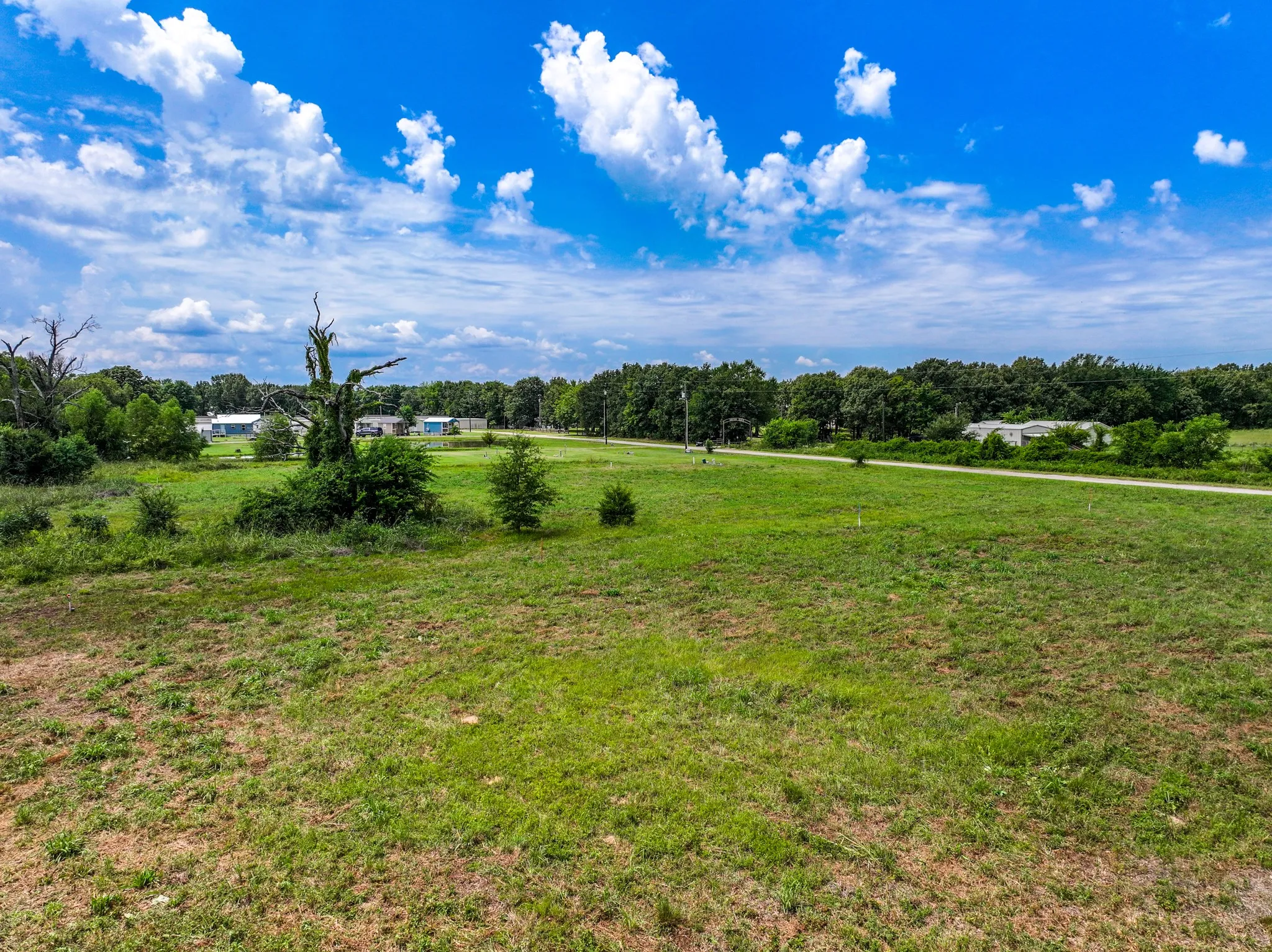 Expansive undeveloped land featuring a mixture of green grass and natural brush