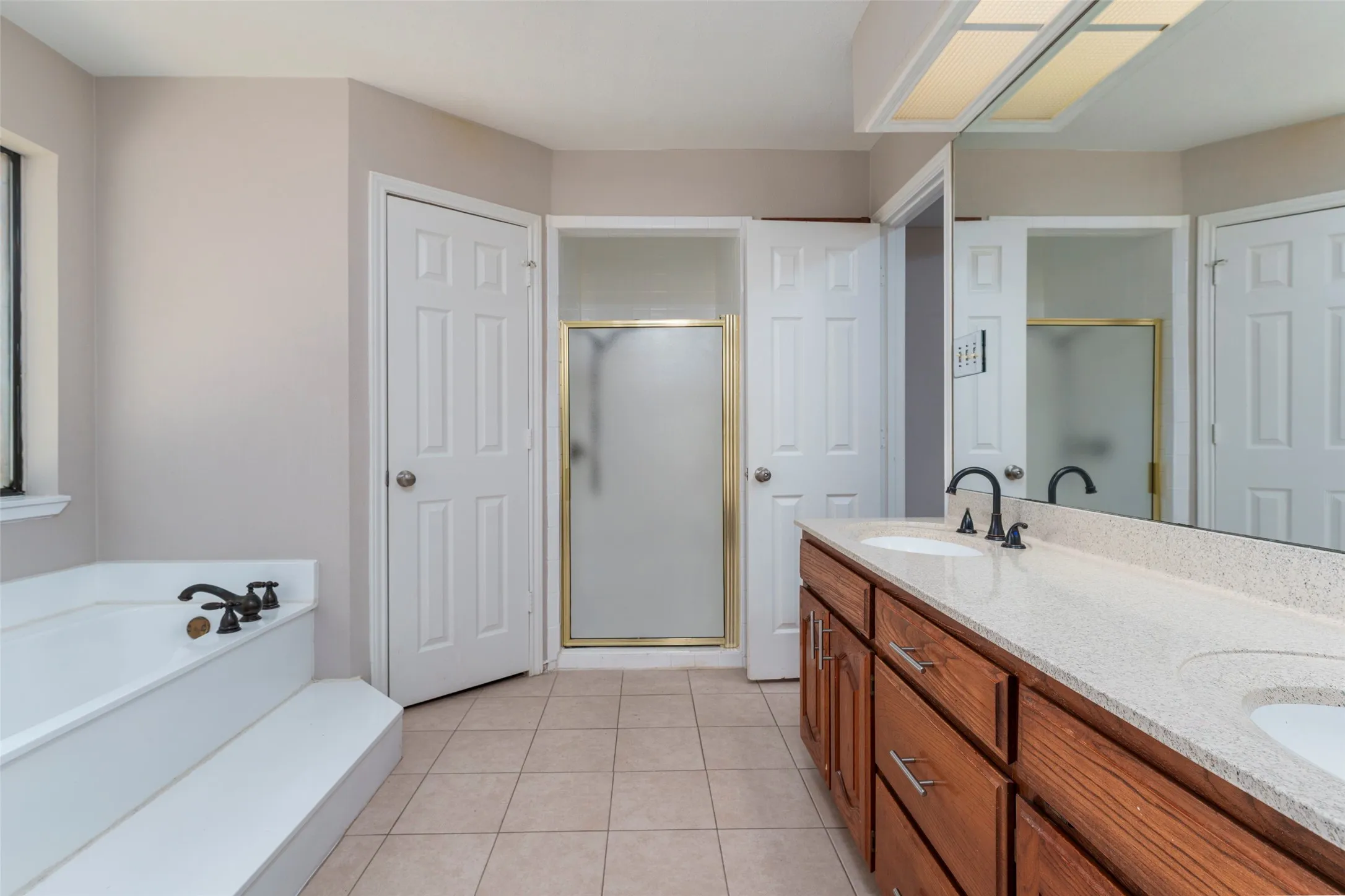 Primary bathroom with his and hers closets