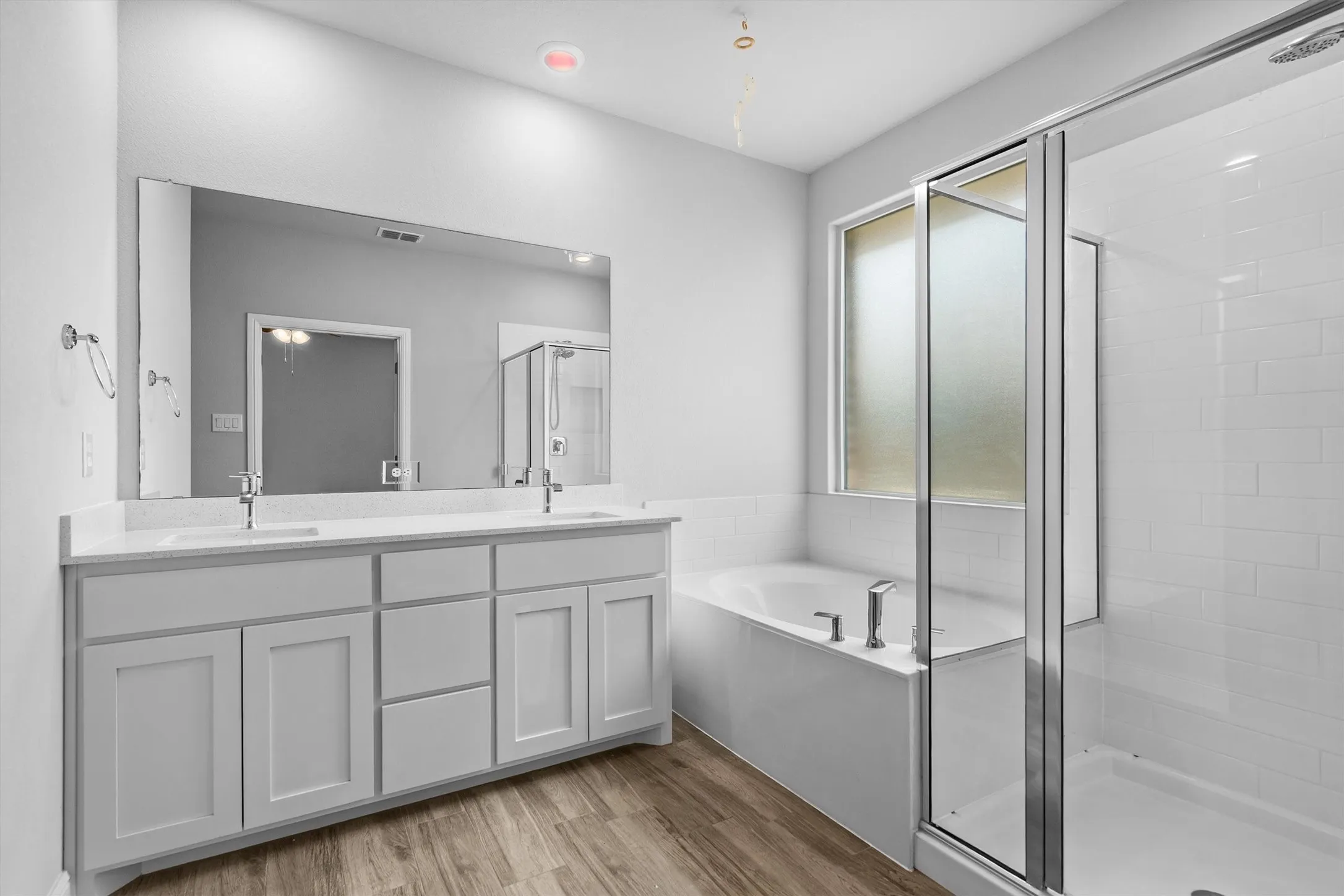Primary bathroom with dual sinks and separate shower