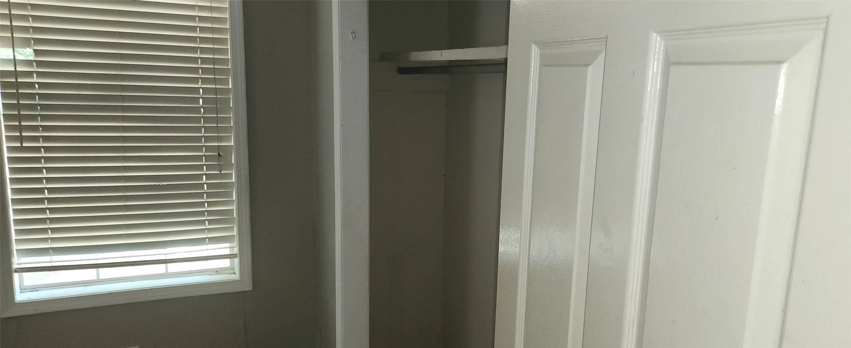 Recessed window featuring horizontal blinds