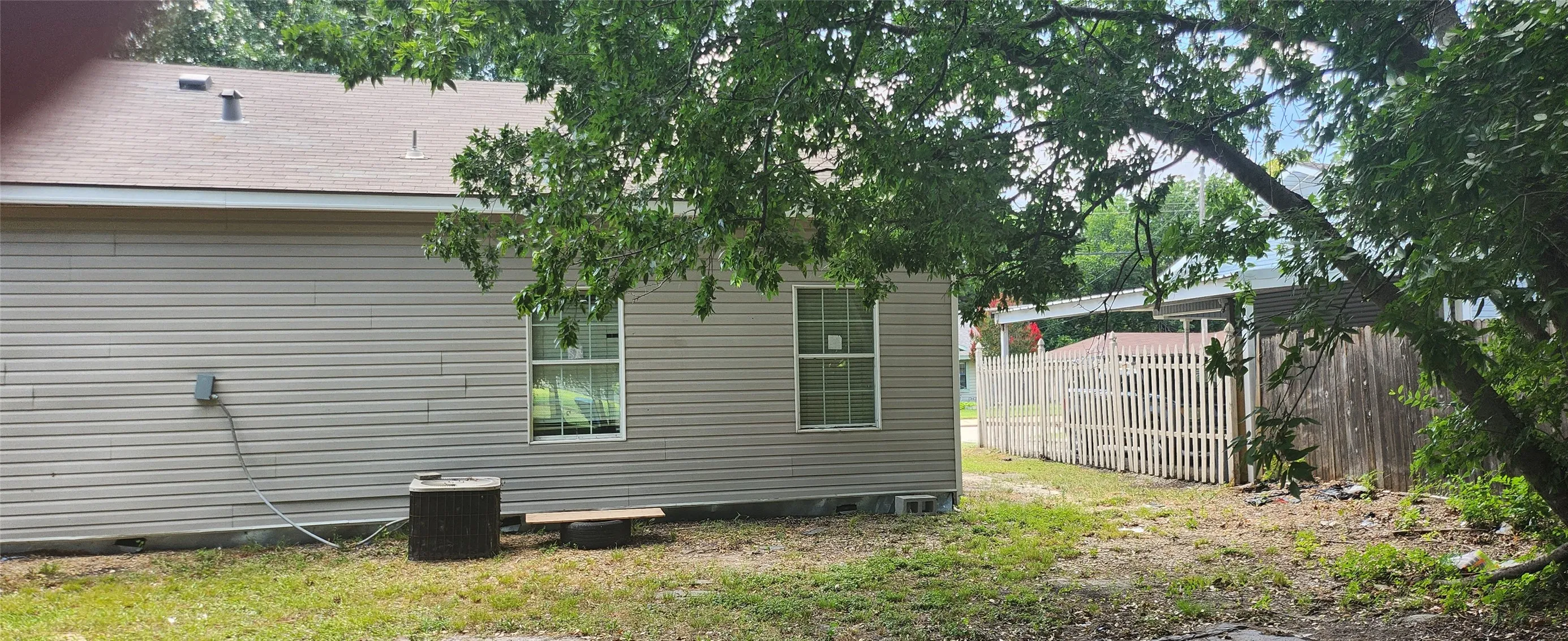 Light gray vinyl siding with two vertical windows