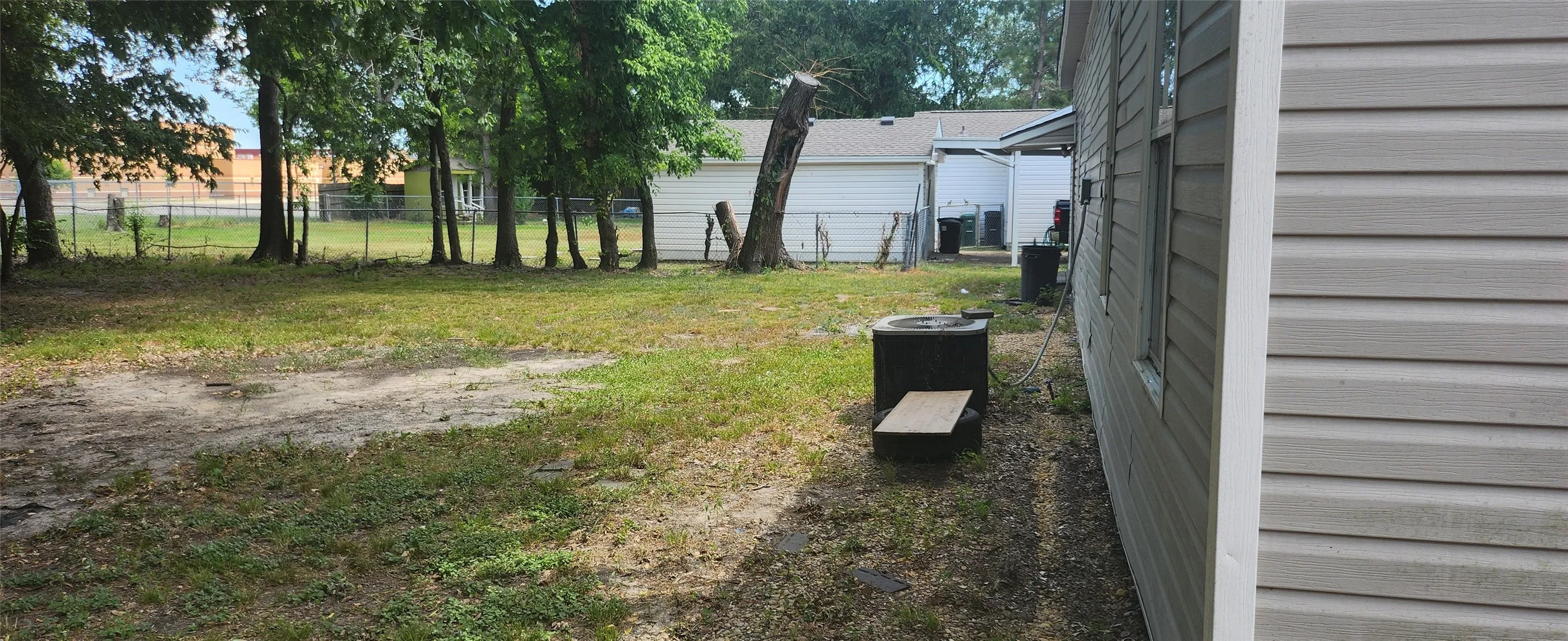 Expansive backyard featuring mature trees