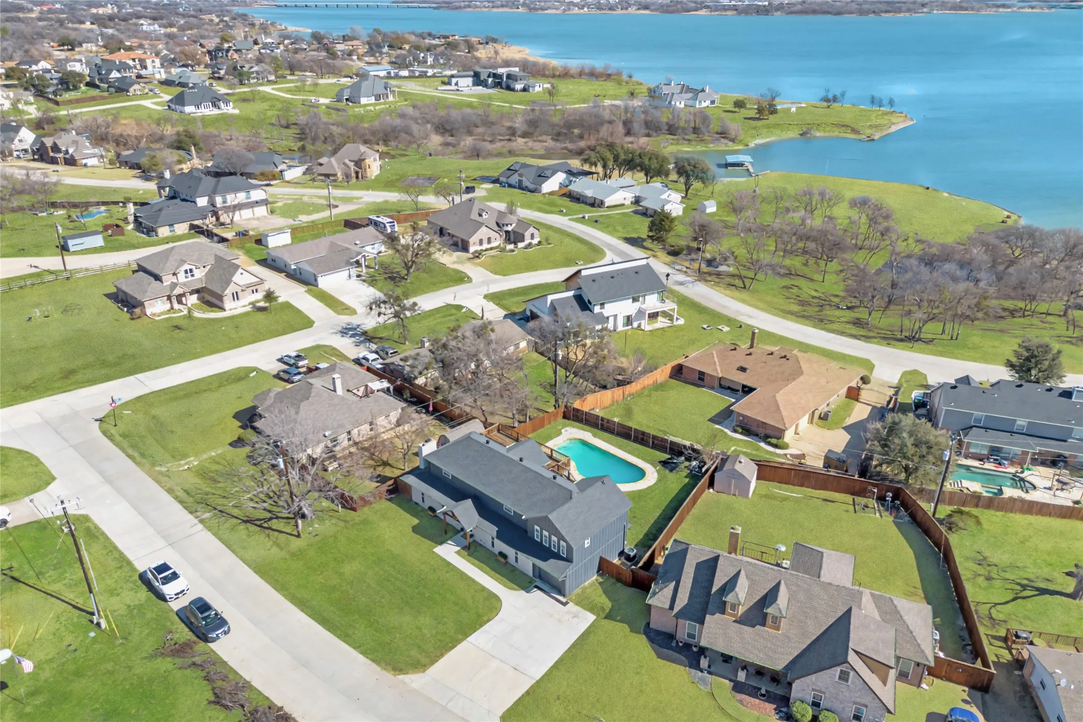 Aerial perspective showcasing a residential area with manicured lawns and mature trees