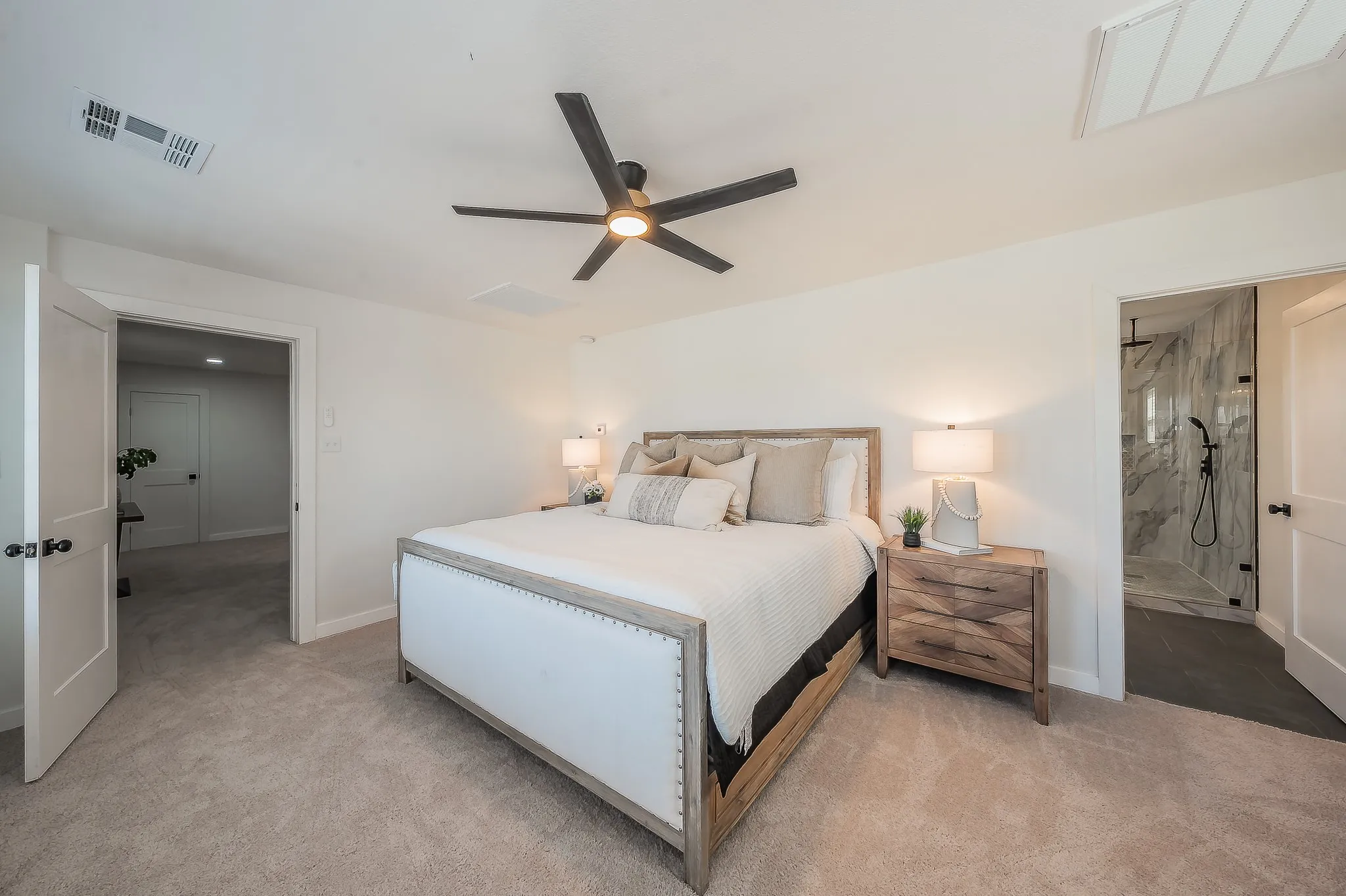 Spacious room featuring neutral carpet flooring, a contemporary ceiling fan, and recessed lighting