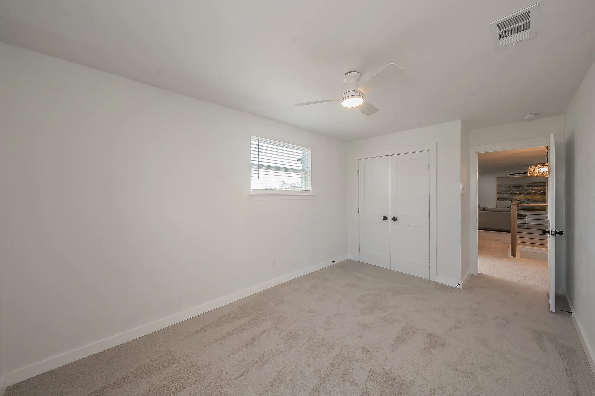 Room featuring light-toned carpeting and white painted walls