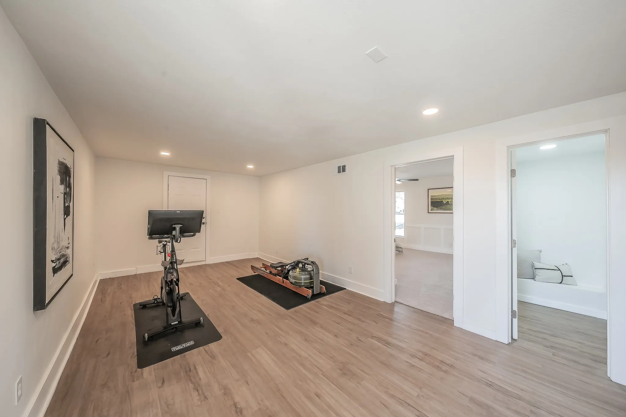 Versatile bonus room featuring wood-finish flooring and recessed lighting
