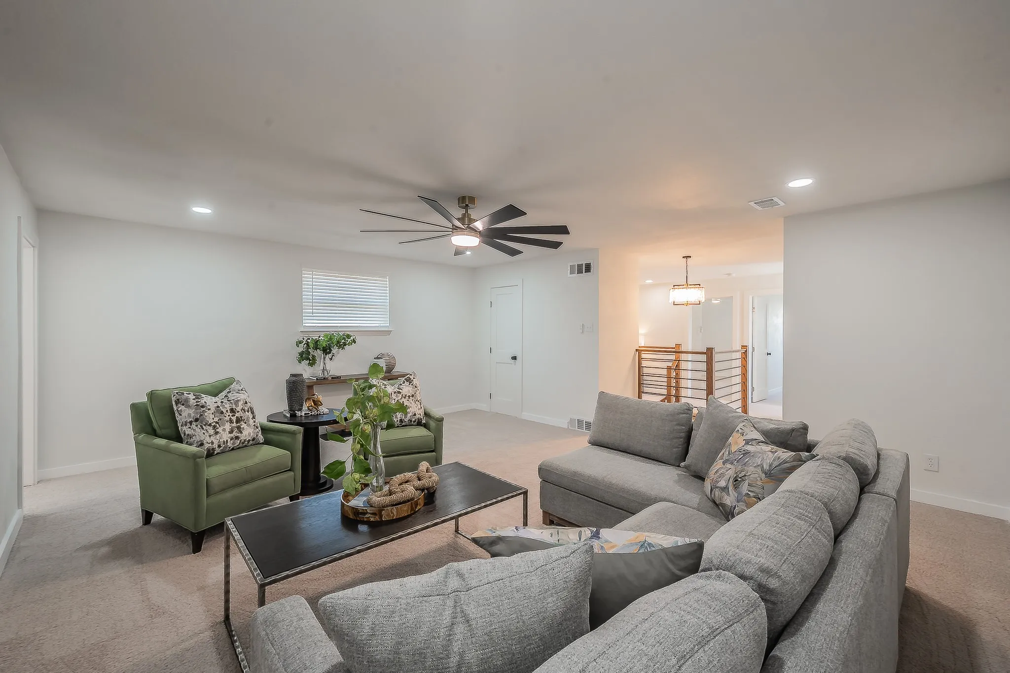 Carpeted living area featuring recessed lighting, a ceiling fan, and light-colored walls