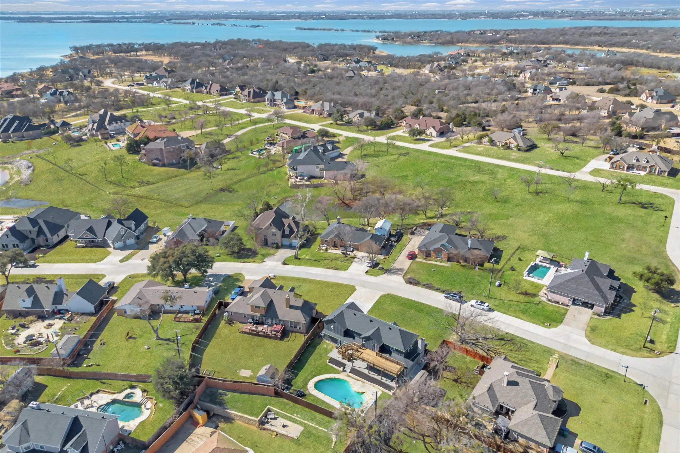 Aerial perspective showcasing a residential community with manicured lawns and mature trees