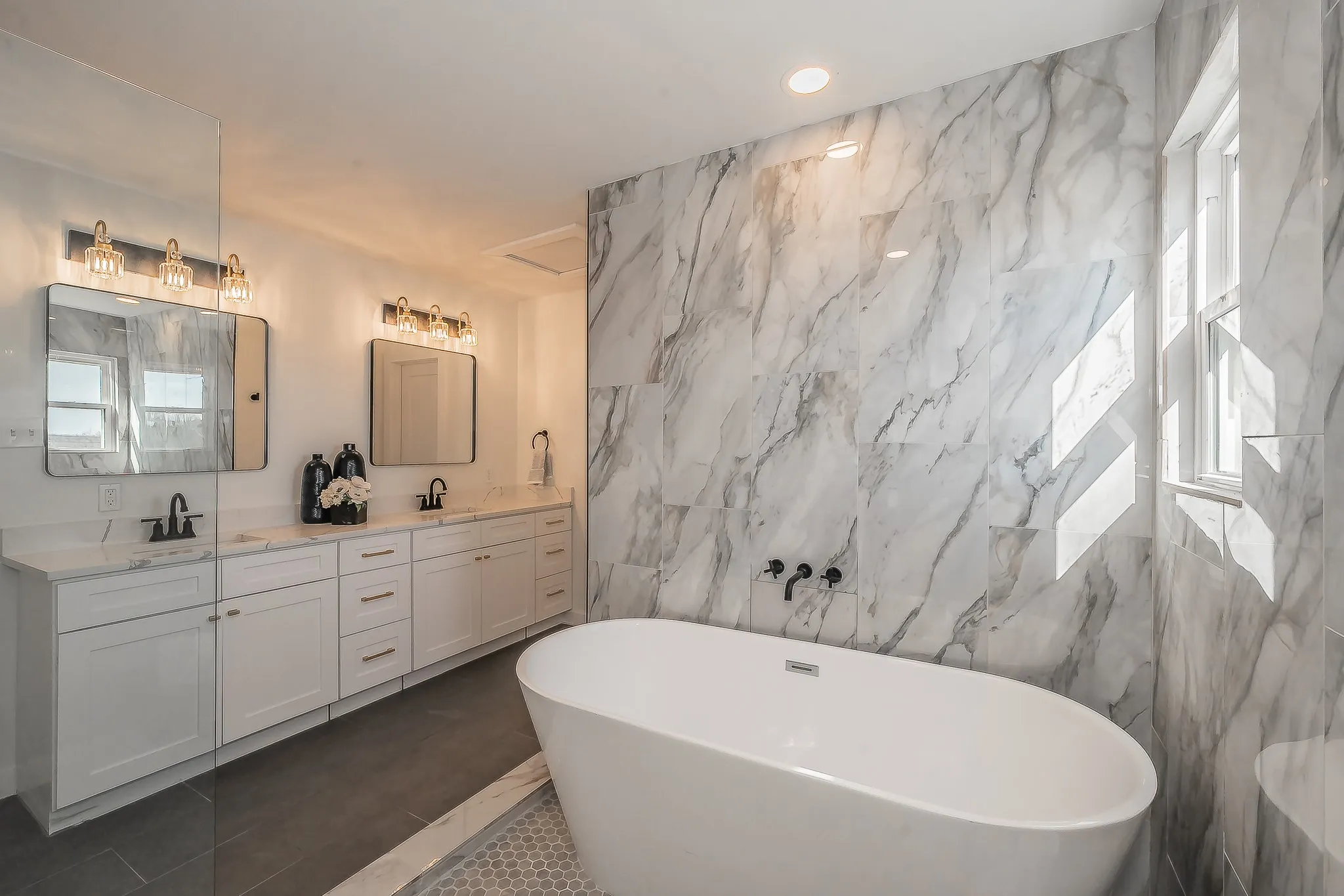 Freestanding soaking tub with wall-mounted fixtures