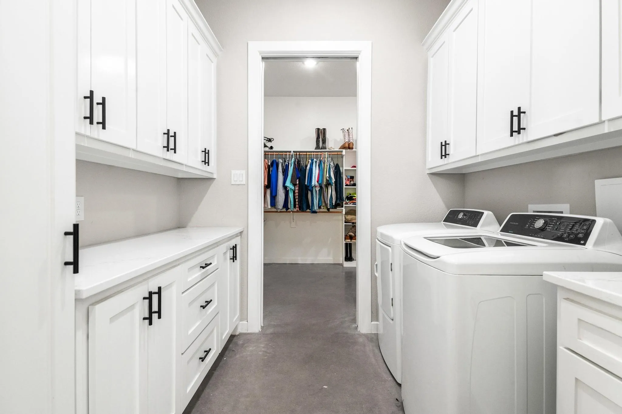 Laundry with sink opens to Primary Closet on other end
