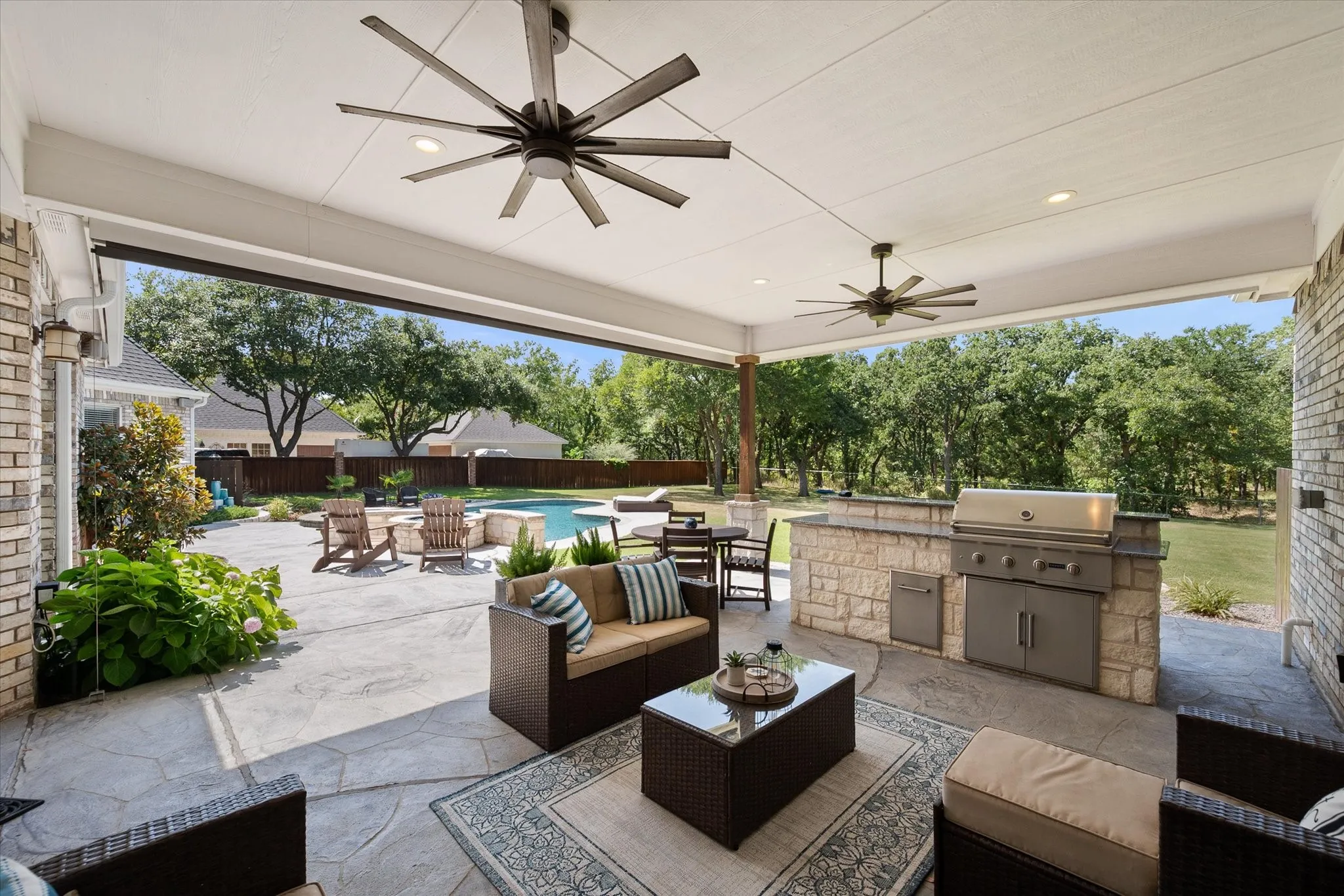 Covered patio with outdoor kitchen and motorized shade.