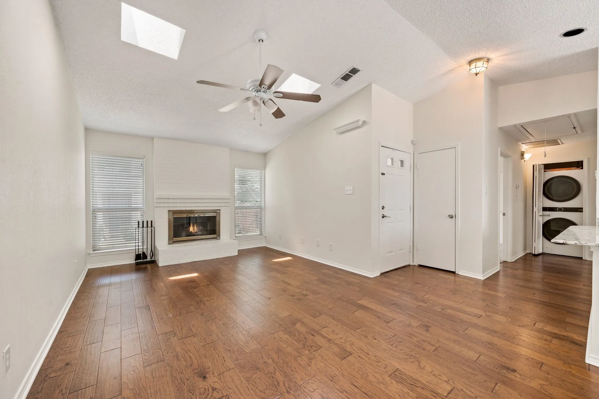 Beautiful wood floors, vaulted ceiling, skylights & fireplace