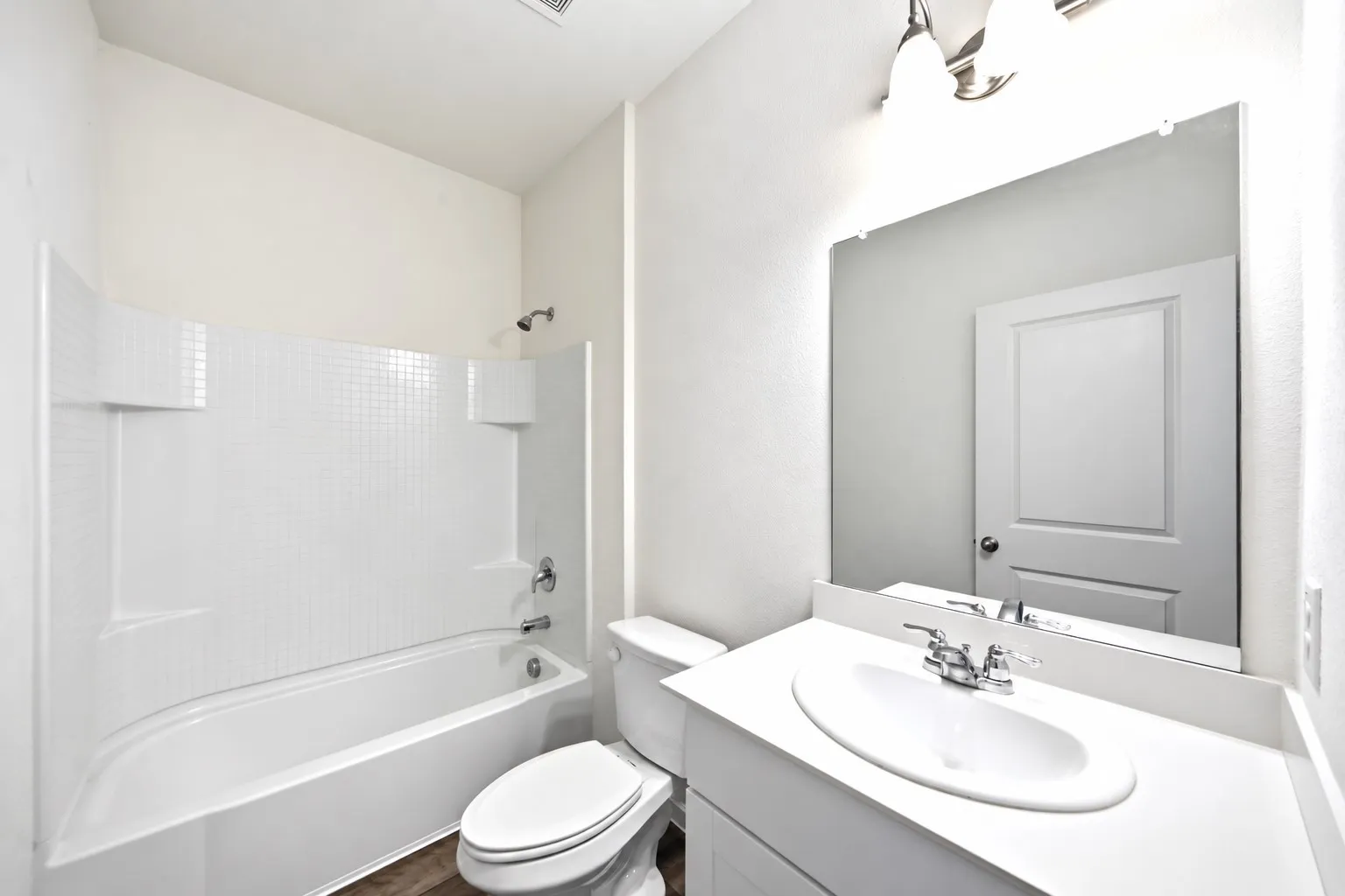 White tile shower surround with integrated shelving