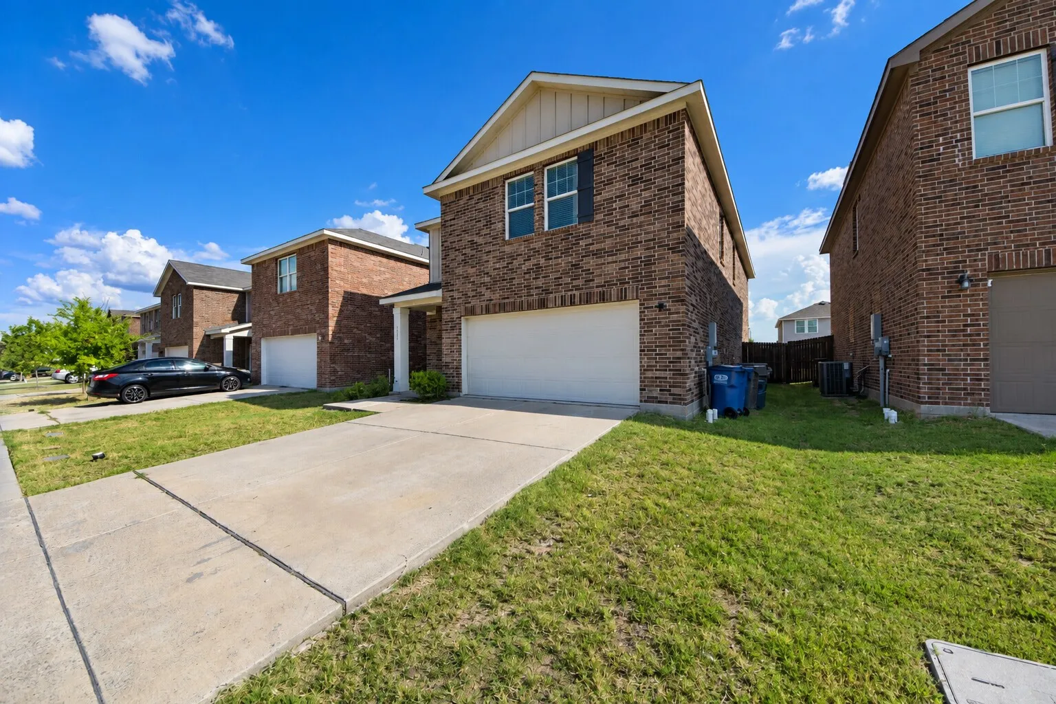 Two-story brick exterior with shutters and a covered porch entry