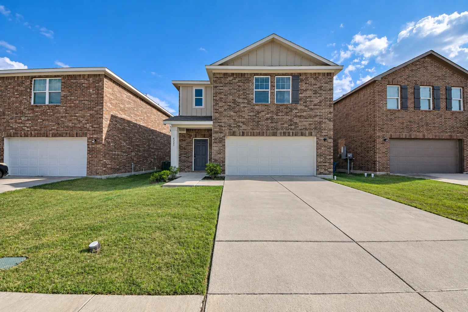 Brick exterior with a gabled roof and front porch entry