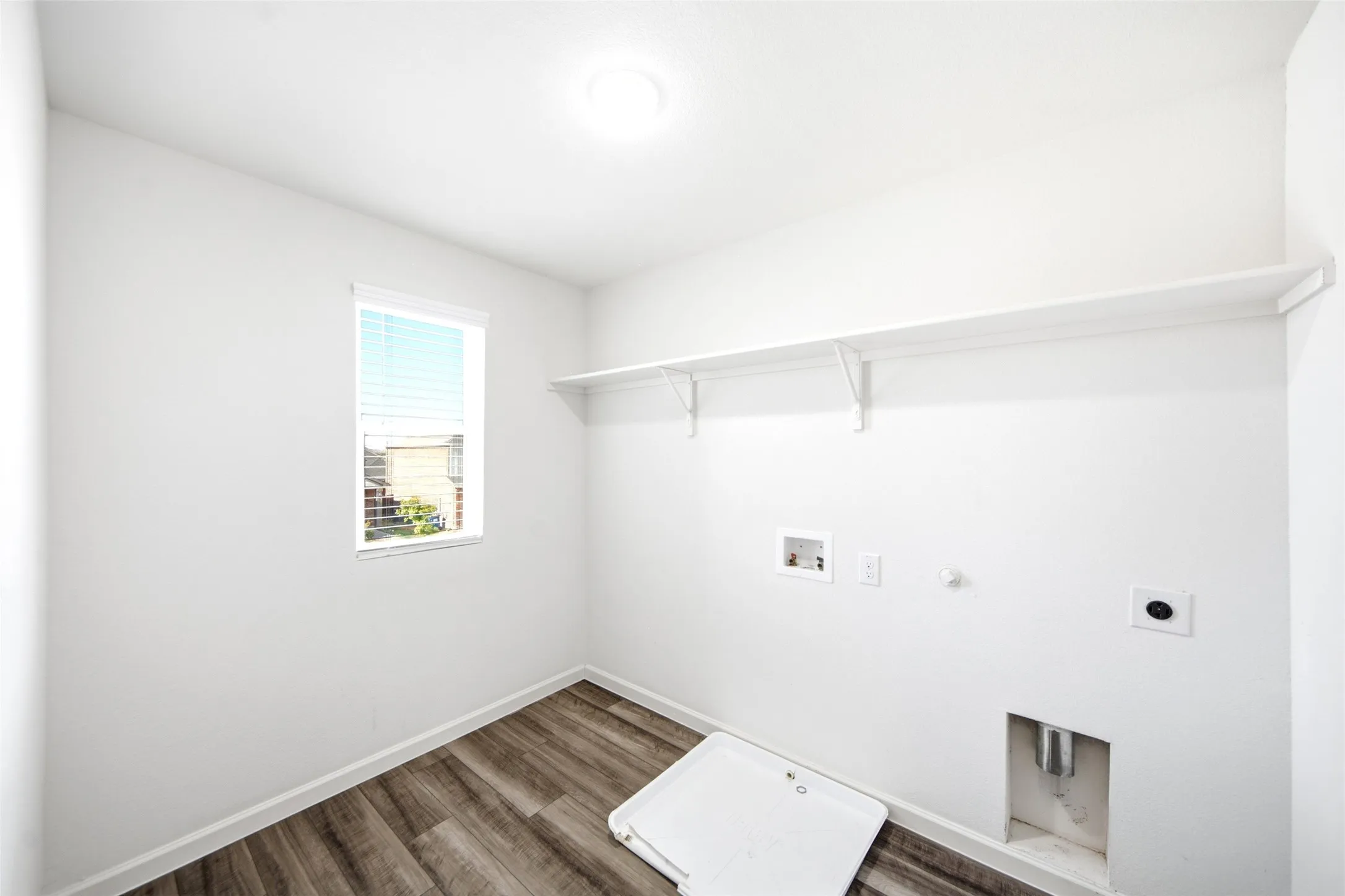 Wood-finish flooring, overhead lighting, and an integrated wall shelf