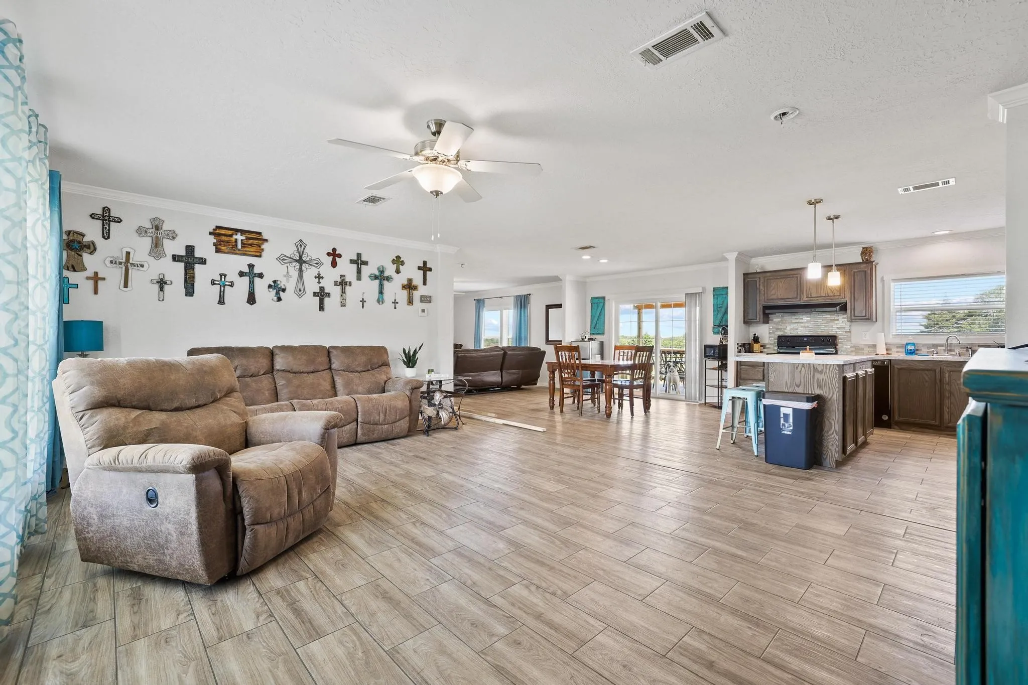 Open-concept living space featuring wood-finish flooring, recessed lighting, and a ceiling fan