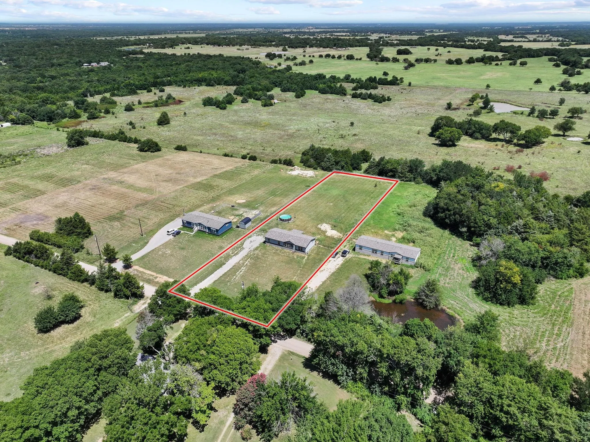 Aerial perspective highlighting multiple structures on a spacious parcel