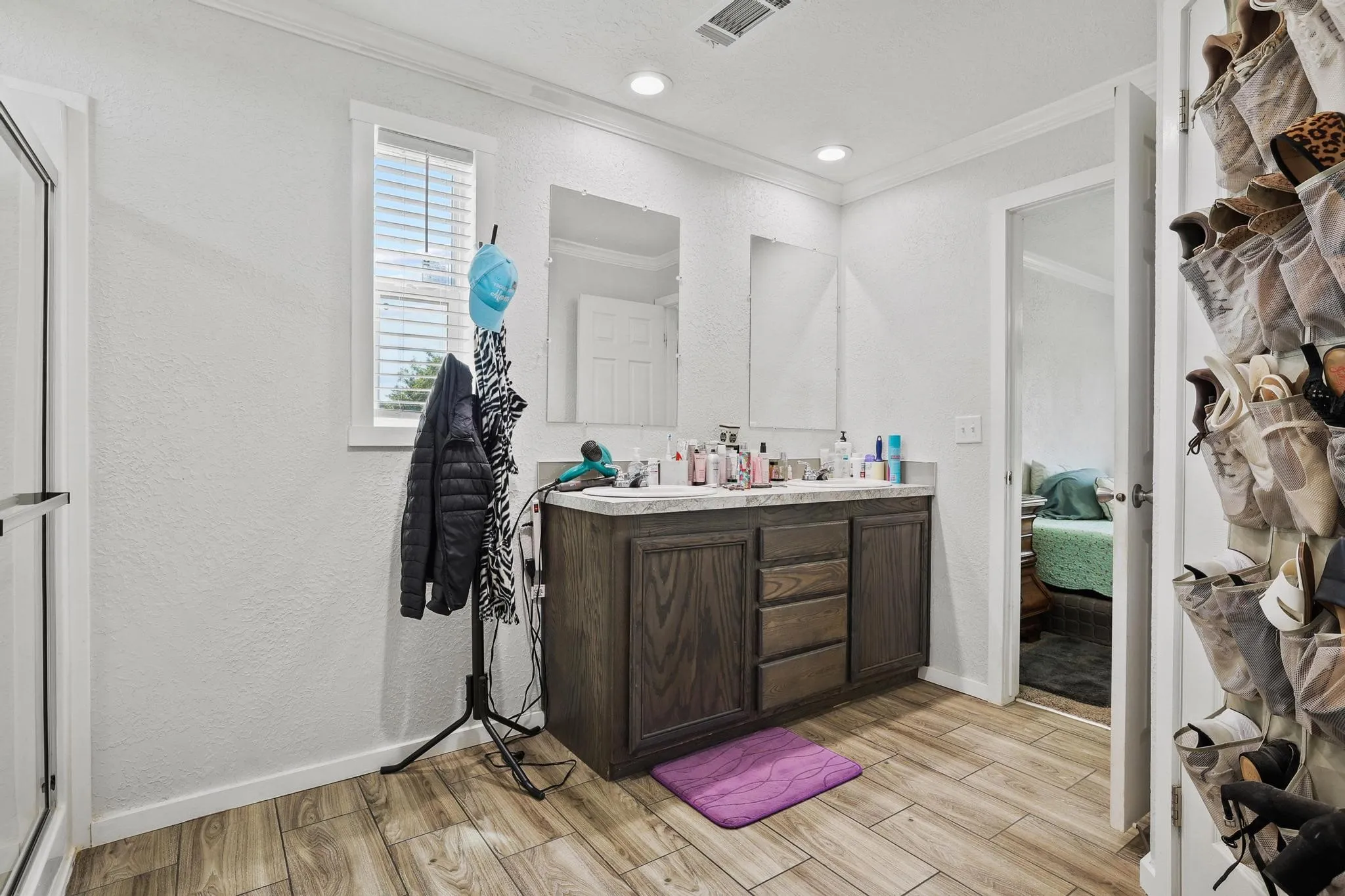 Double vanity with wood-finish cabinetry and dual undermount sinks