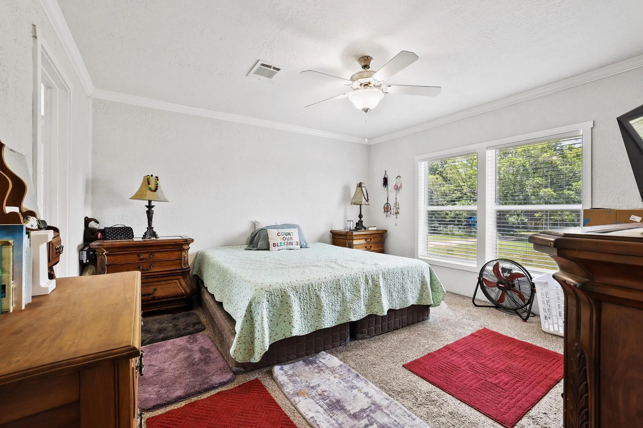 Bright room featuring white walls and a textured ceiling
