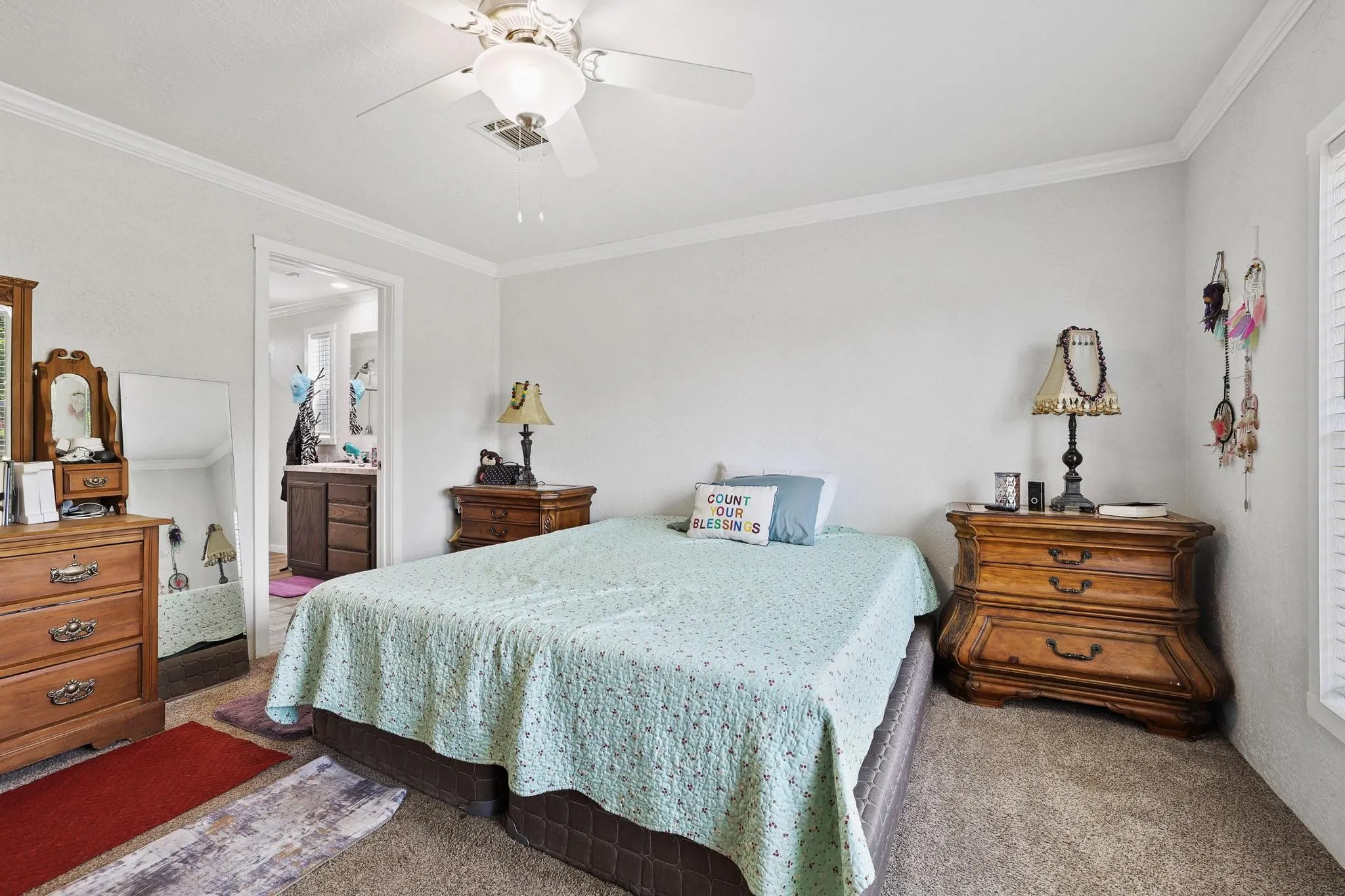 Carpeted room with crown molding and white walls