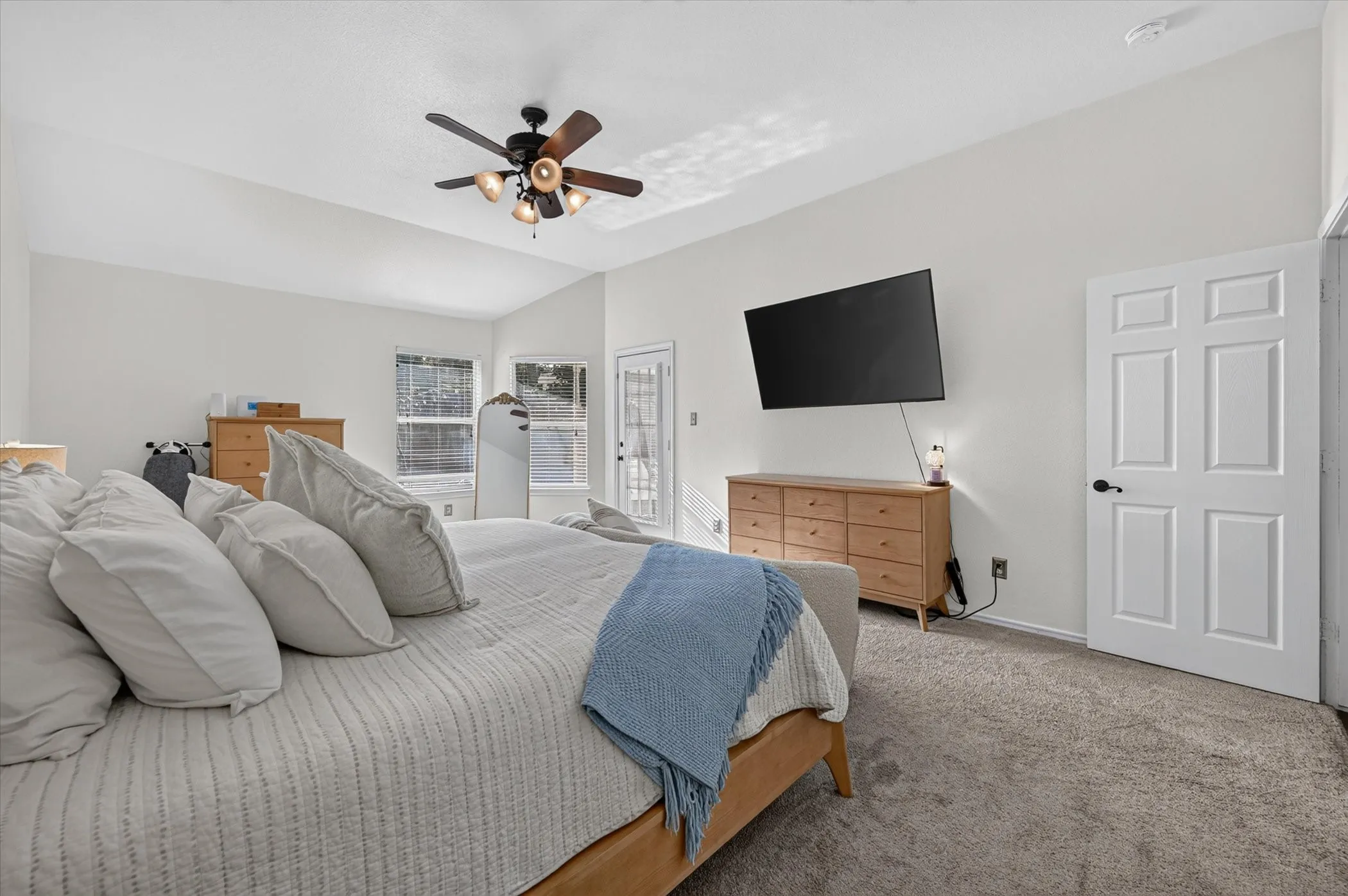 Vaulted ceilings and light-colored walls create an expansive interior