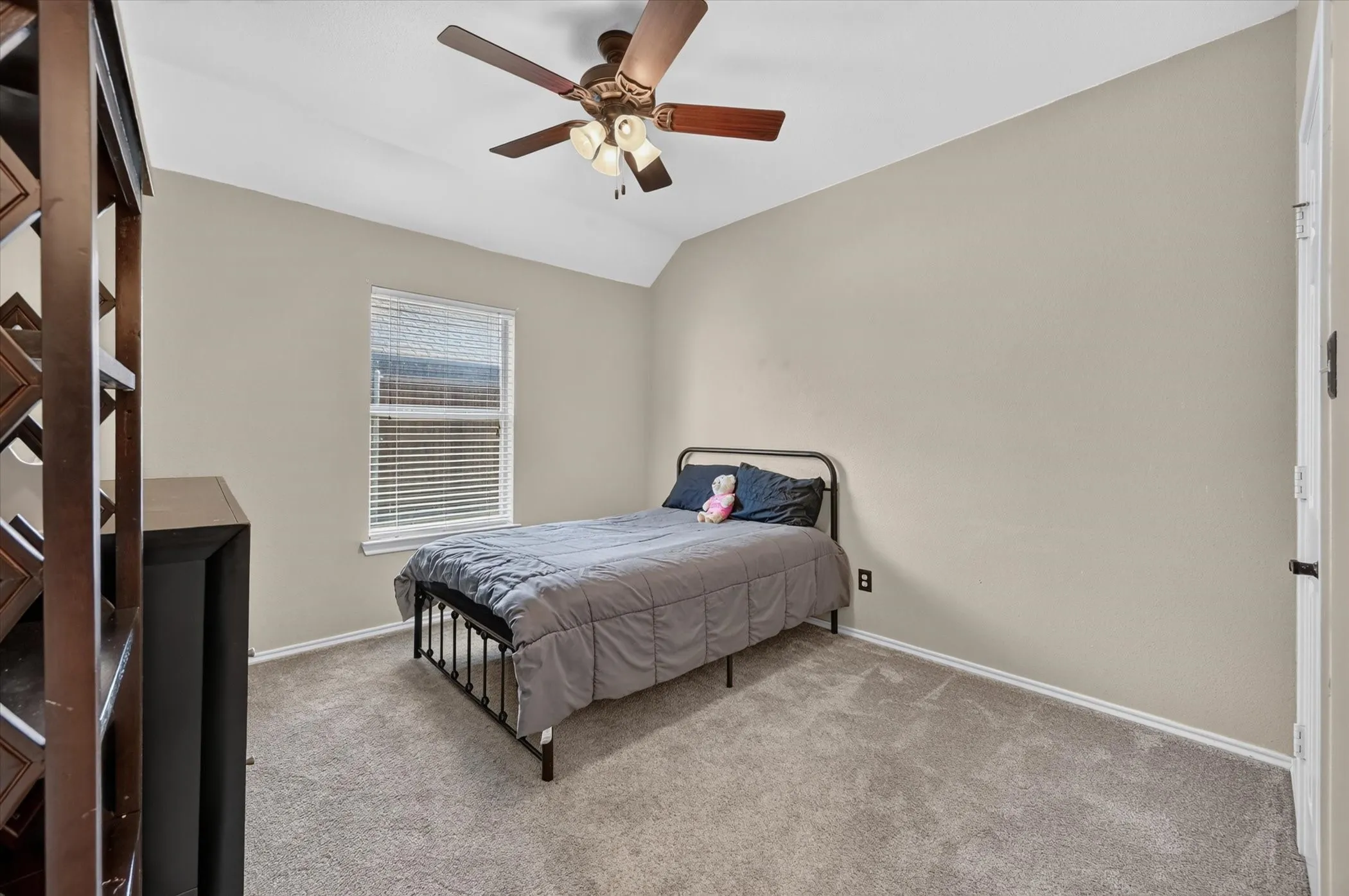 Carpeted room with a ceiling fan, window with blinds, and light-toned walls