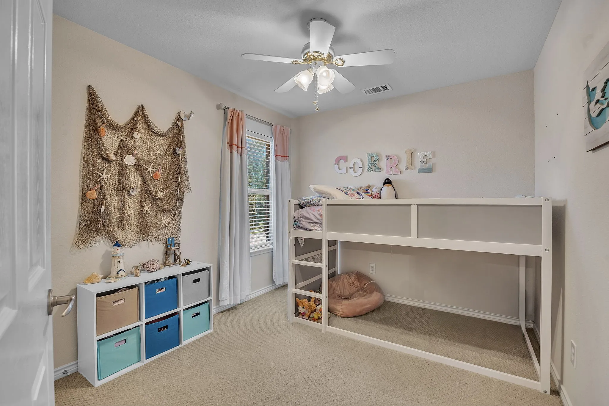 Carpeted flooring, ceiling fan with integrated lighting, and window with blinds and drapes