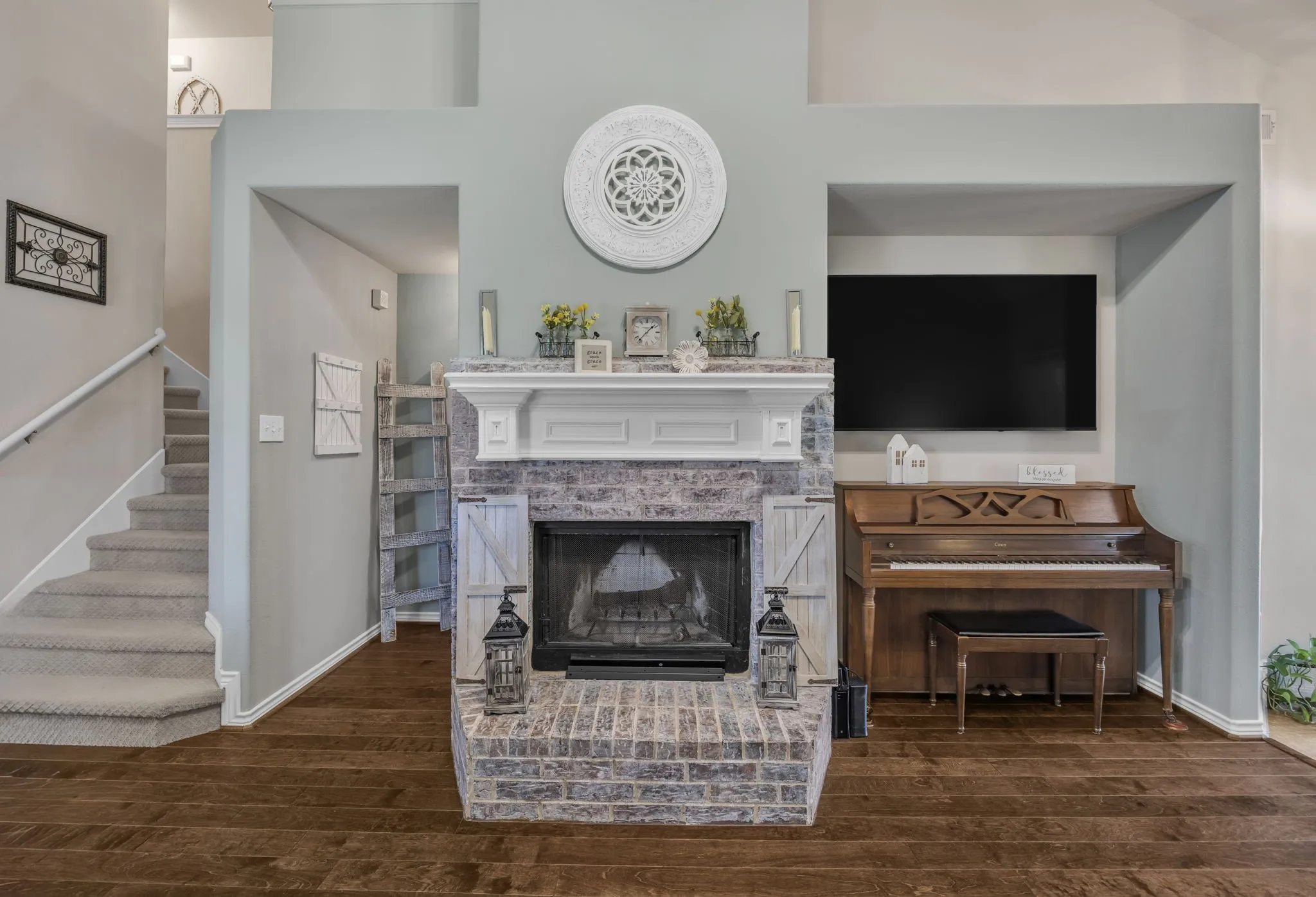 Brick wood burning fireplace with a white mantel.