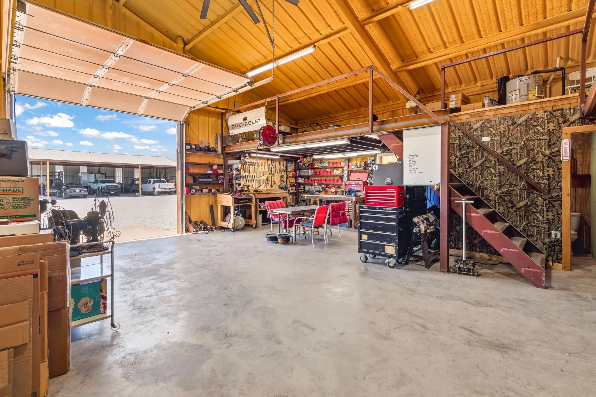 Fully insulated 30' x 40' shop with a full bathroom and spacious bay door for easy equipment access or parked vehicles, plus an added staircase leading to a two-sided loft that offers plenty of extra storage - aa dream setup for a hobbyists, tradesmen, or anyone needing serious workspace.