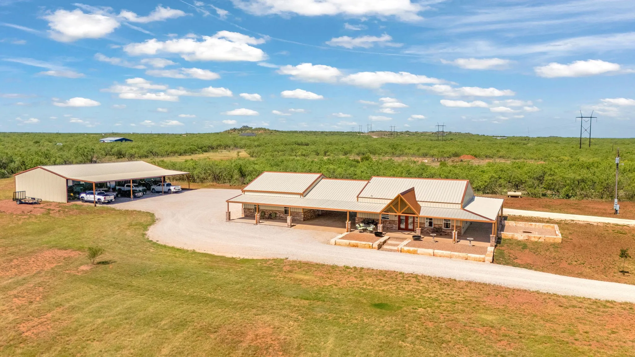 Front of barndominium, circle drive and 40'x75' machine shop with 20'x75' awning attached.