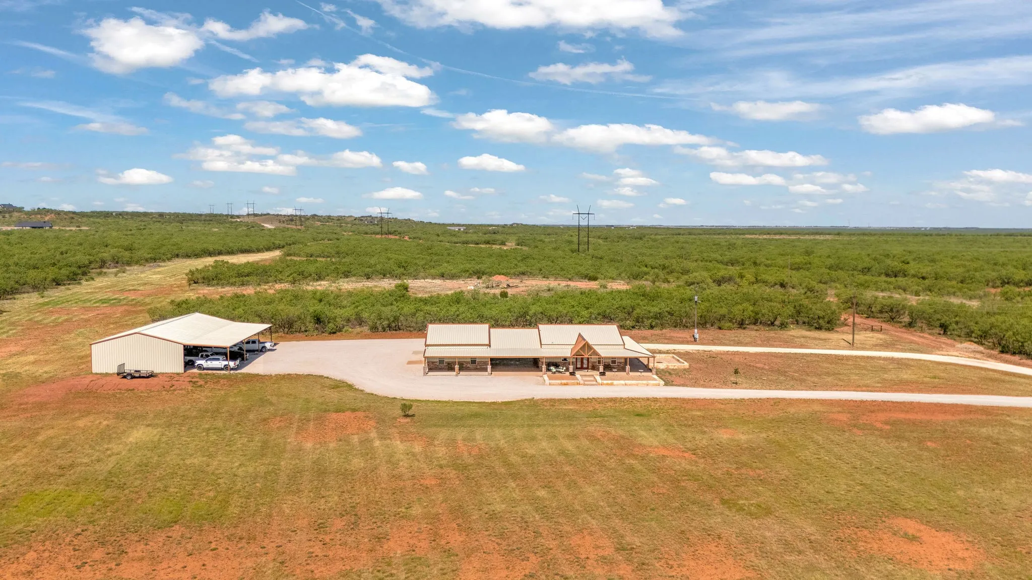 33 acres, two worlds. Open pasture stretches out front while mesquite woods frame the back.  This barndominium home with workshop and machine shed sit right where they meet.