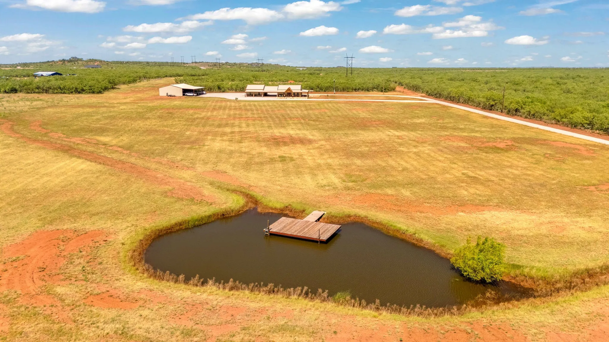 Wide-open acreage meets a private tank with its own dock - country living at its finest, peaceful living done right.
