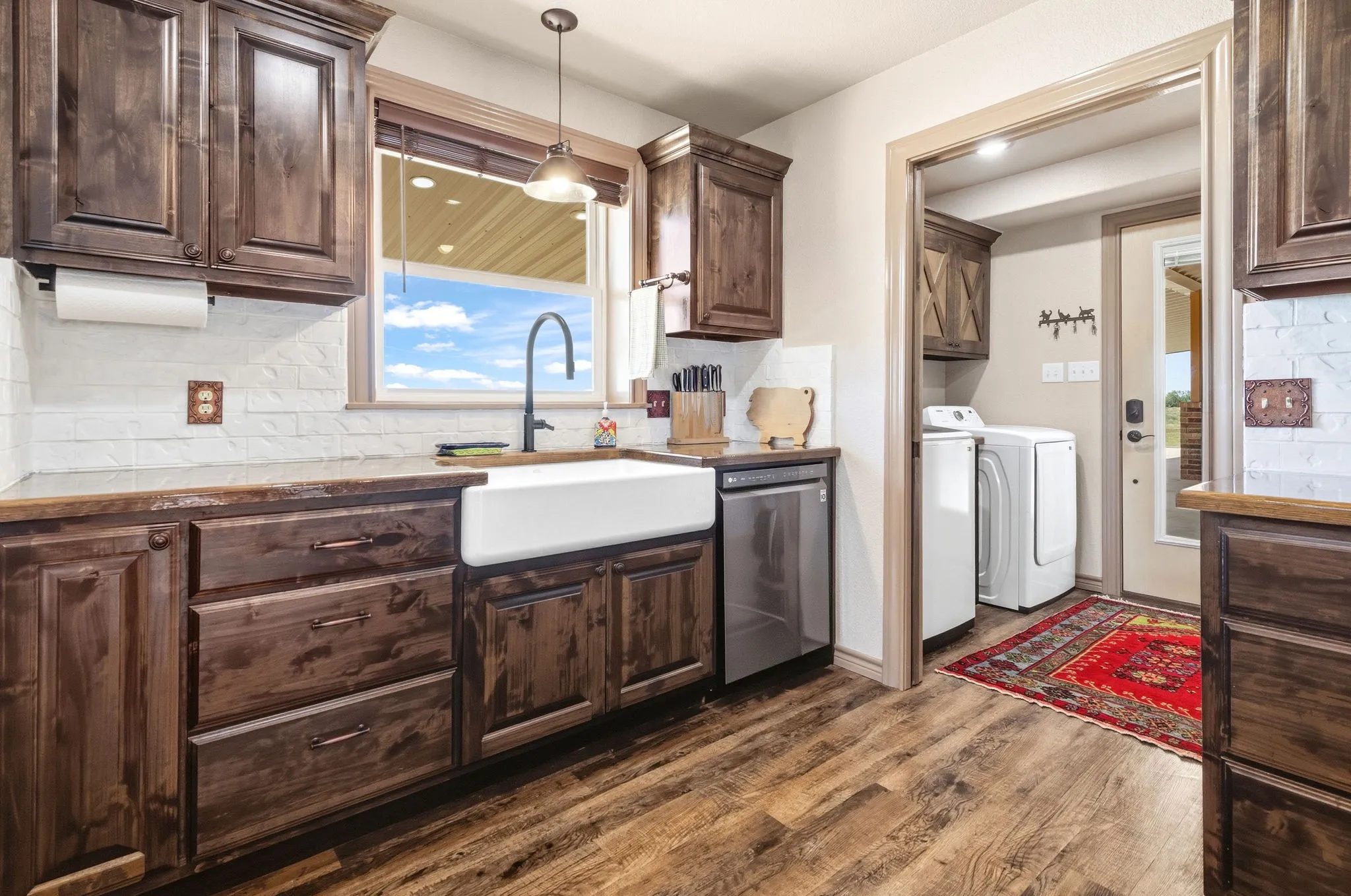 Laundry room conveniently steps away from side door leading out to the breezeway and shop. After a day of big projects out in the shop, just toss your work clothes straight into the washer, no trekking dirt and grime through the house.