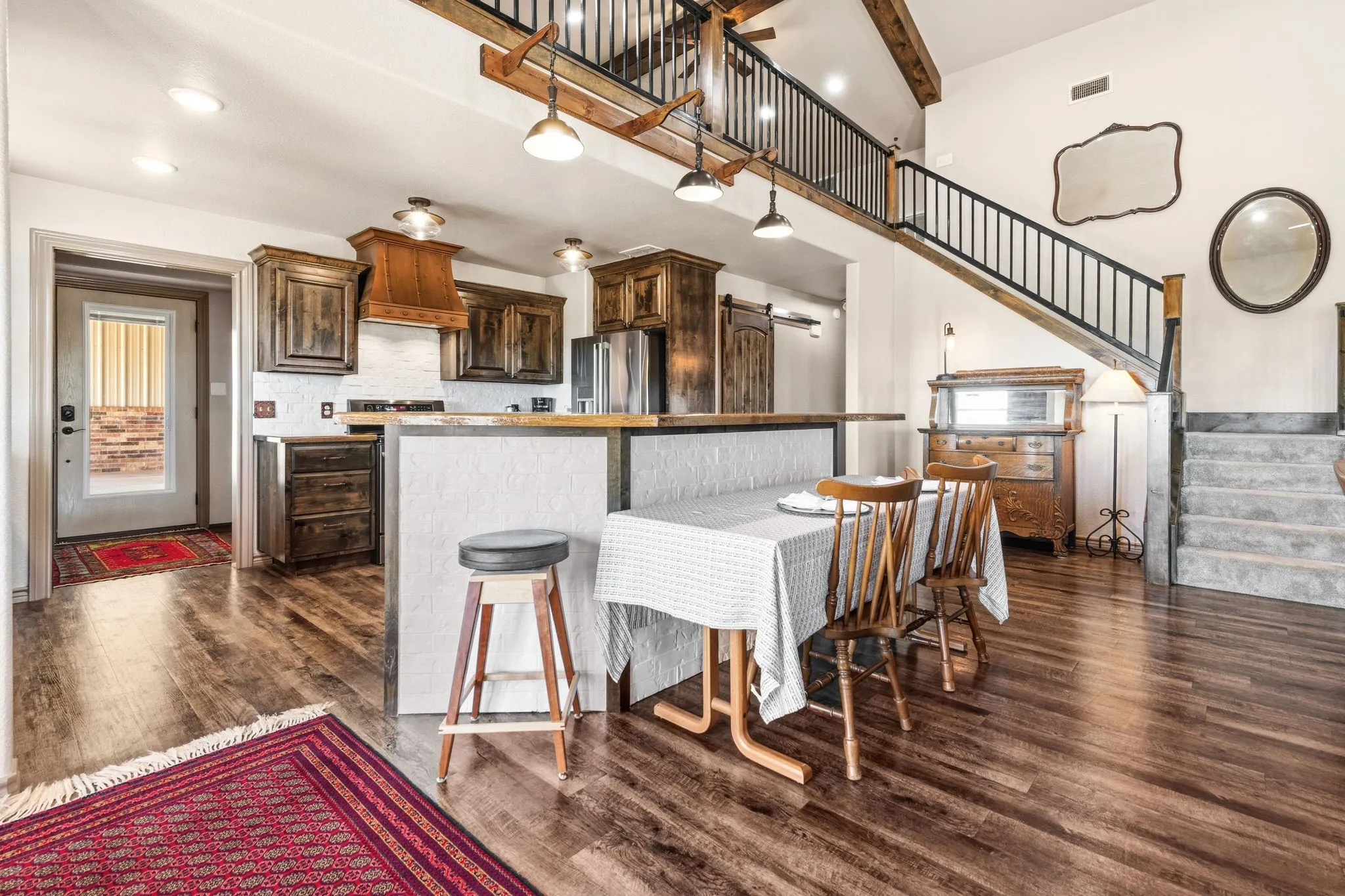 Rich stained cabinetry and a spacious island create the heart of this eat-in kitchen, with built-in seating for four at the counter and plenty of room to pull in a table for larger gatherings-an easy, welcoming space for everyday meals or entertaining.