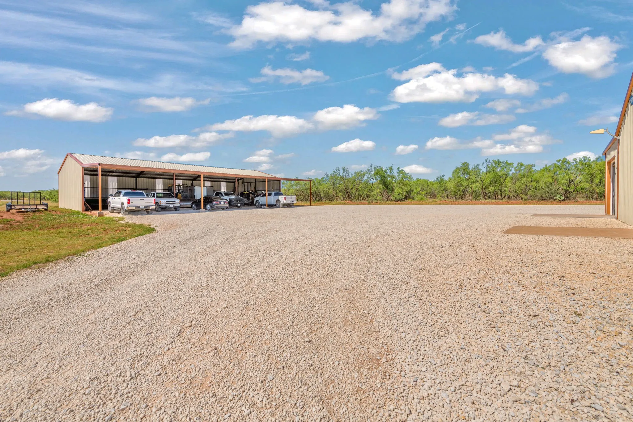 Expansive 80'x100' gravel parking area gives room for trucks, trailers or equipment, while the 40'x75' machine shed with a 20'x75' awning offers serious covered storage for all of your vehicles and gear.