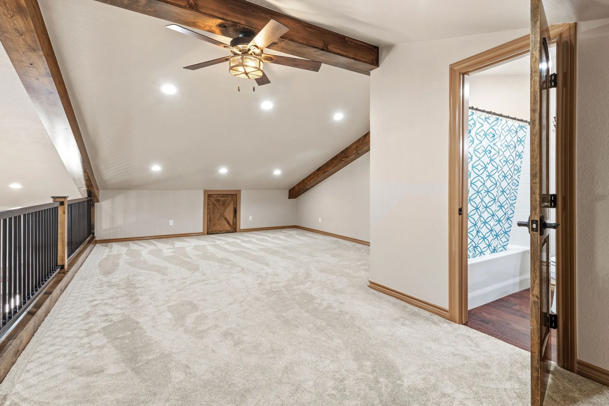 Spacious upstairs loft with vaulted, beamed ceilings and its own attached bathroom, offering incredible flexibility as a third bedroom, home office or bonus flex space to fit however you live.