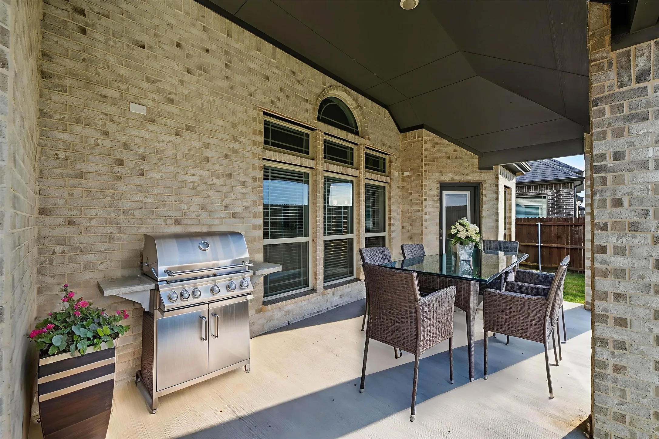 Covered patio with light-colored brick exterior