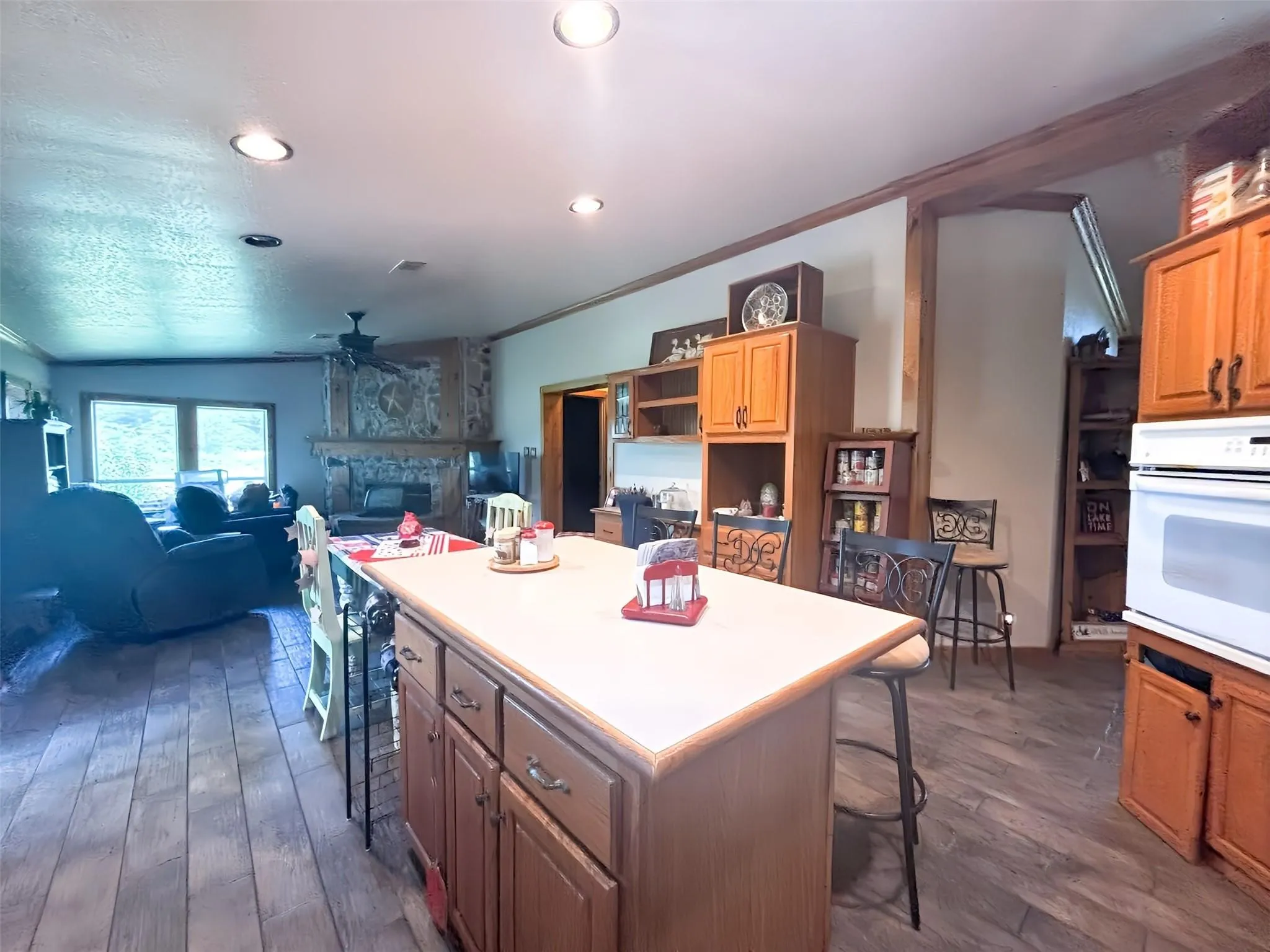 Kitchen island with a light-toned countertop and wood-finish cabinetry
