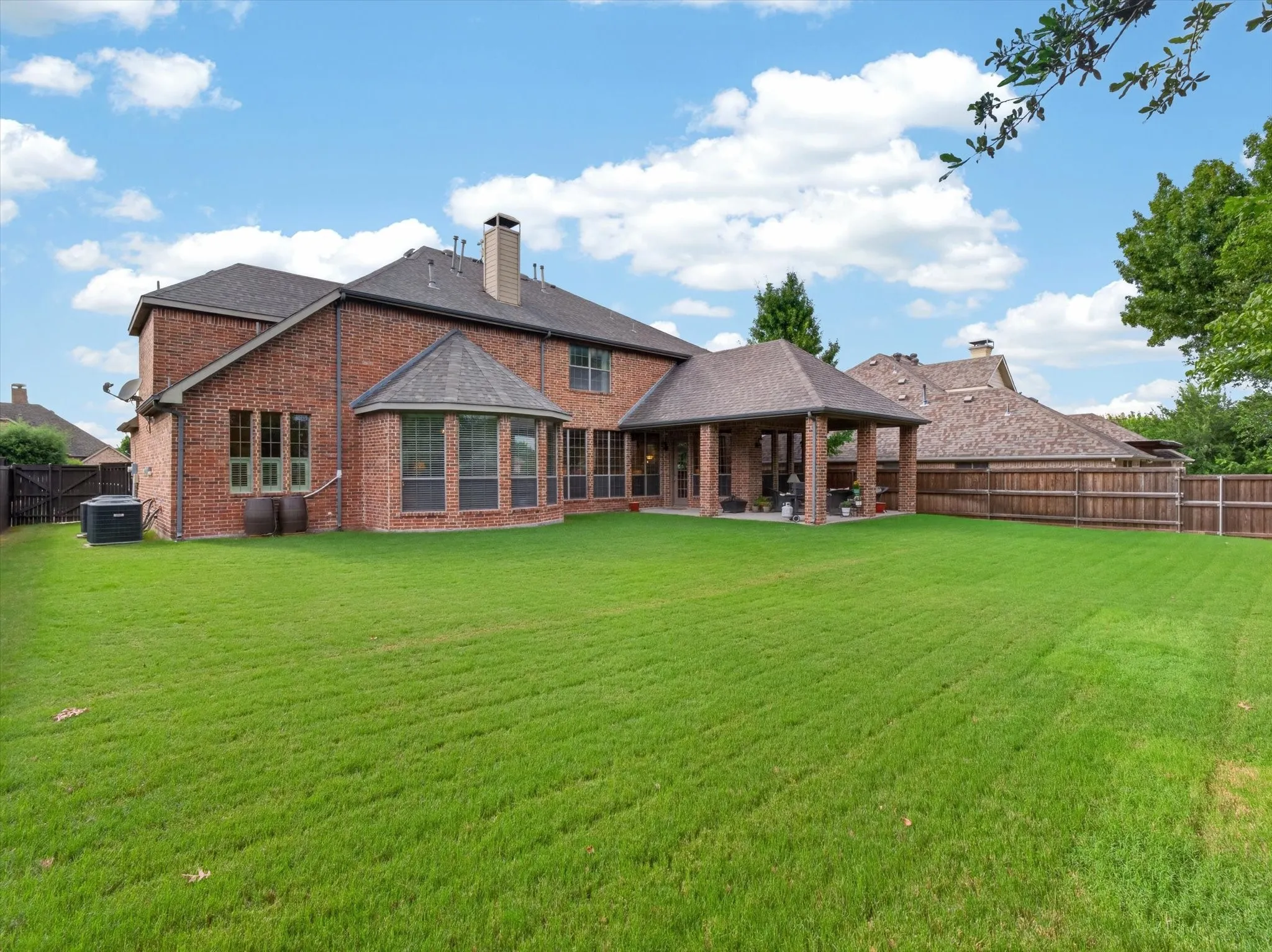 Mature, well-cared for backyard immediately seen upon entering home